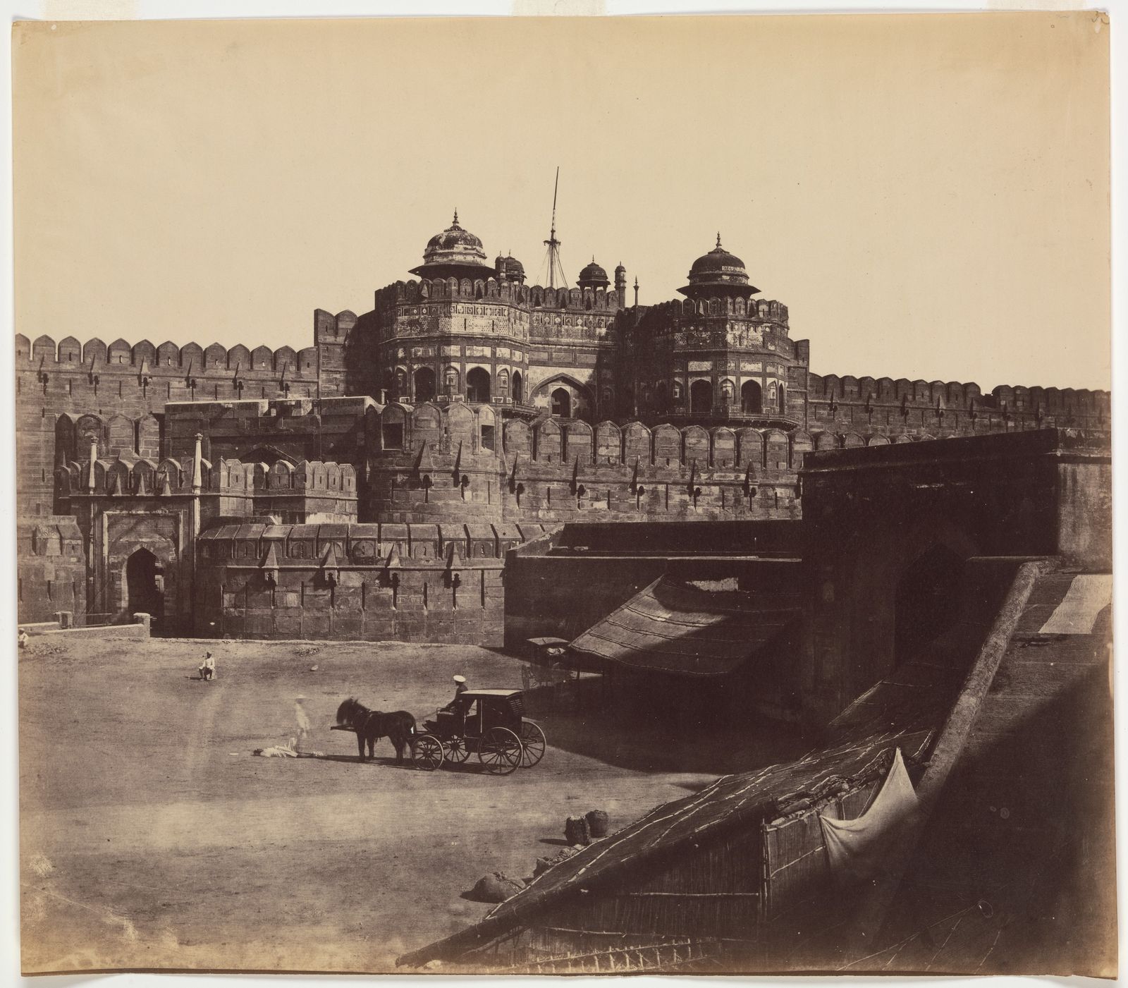 The red sandstone Delhi Gate of Agra Fort with its towers above the moat