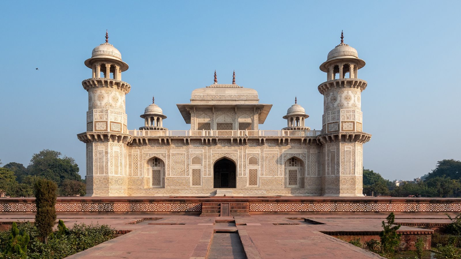 The white marble tomb of Itimad-ud-Daulah in Agra with its four corner towers and inlaid facade