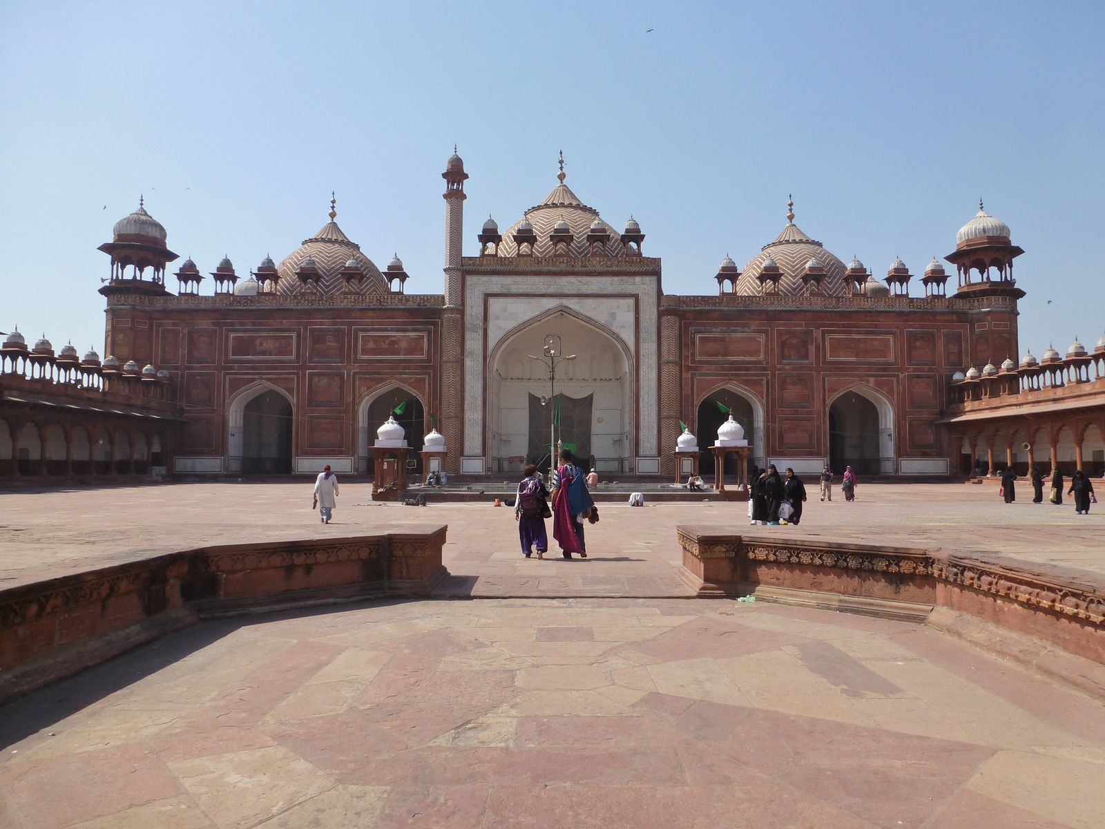 The red sandstone domes of the Jama Masjid in Agra with white zigzag bands