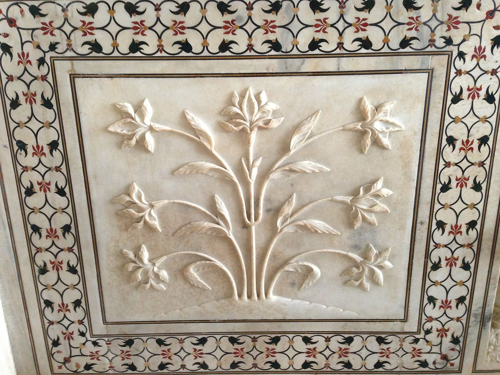 Pietra dura inlay of coloured stone flowers set into the white marble of the Taj Mahal