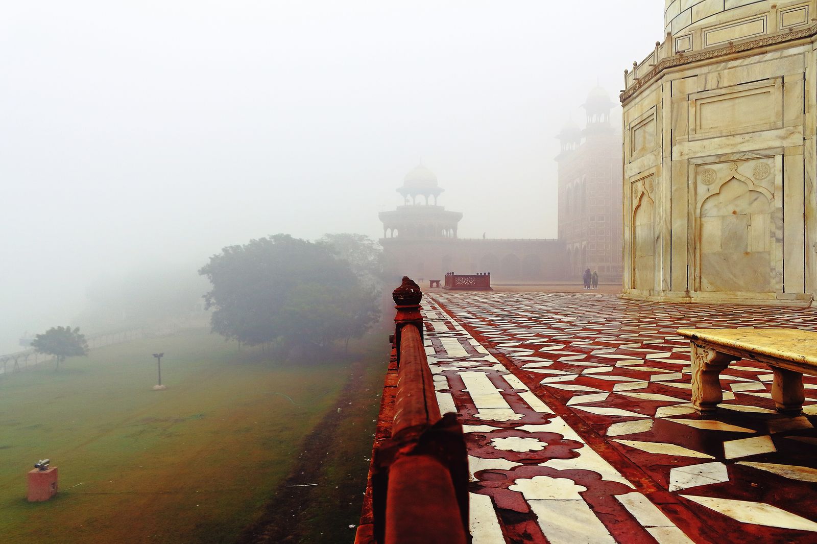 The Taj Mahal softened by winter mist in the early morning, its dome pale against a white sky
