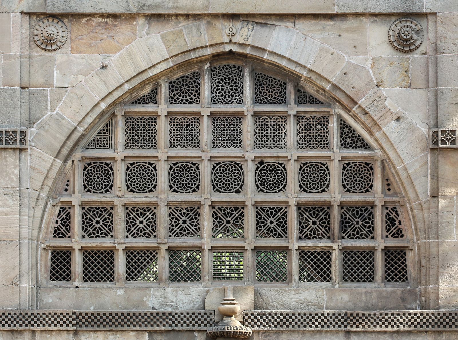 The carved stone lattice of intertwined trees in the window of the Sidi Saiyyed Mosque in Ahmedabad