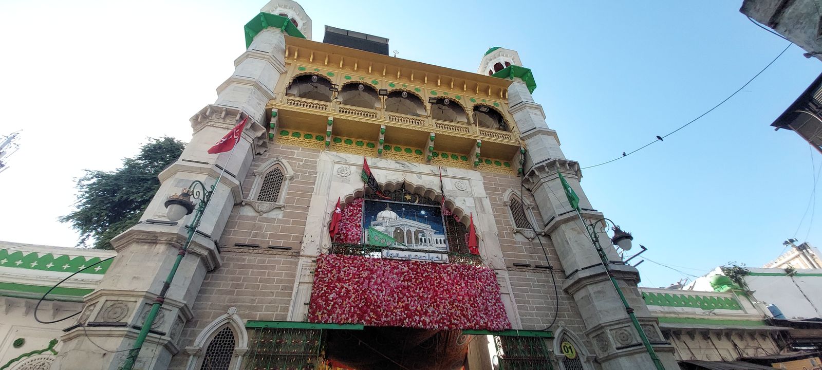 The tall Nizam Gate at the entrance of Ajmer Sharif Dargah with pilgrims passing beneath