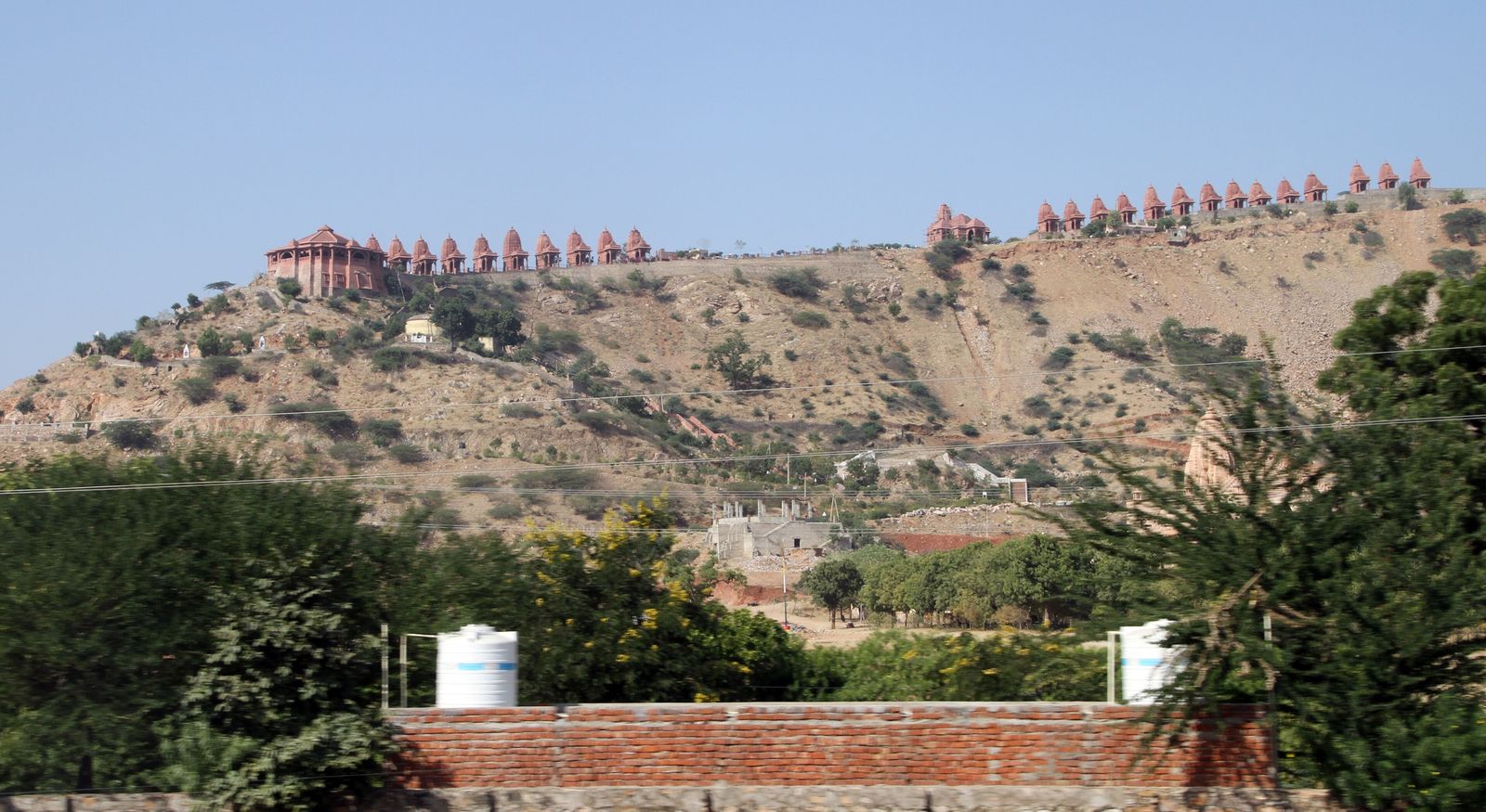 The pale stone shrines of the Nareli Jain temple complex climbing a hillside outside Ajmer