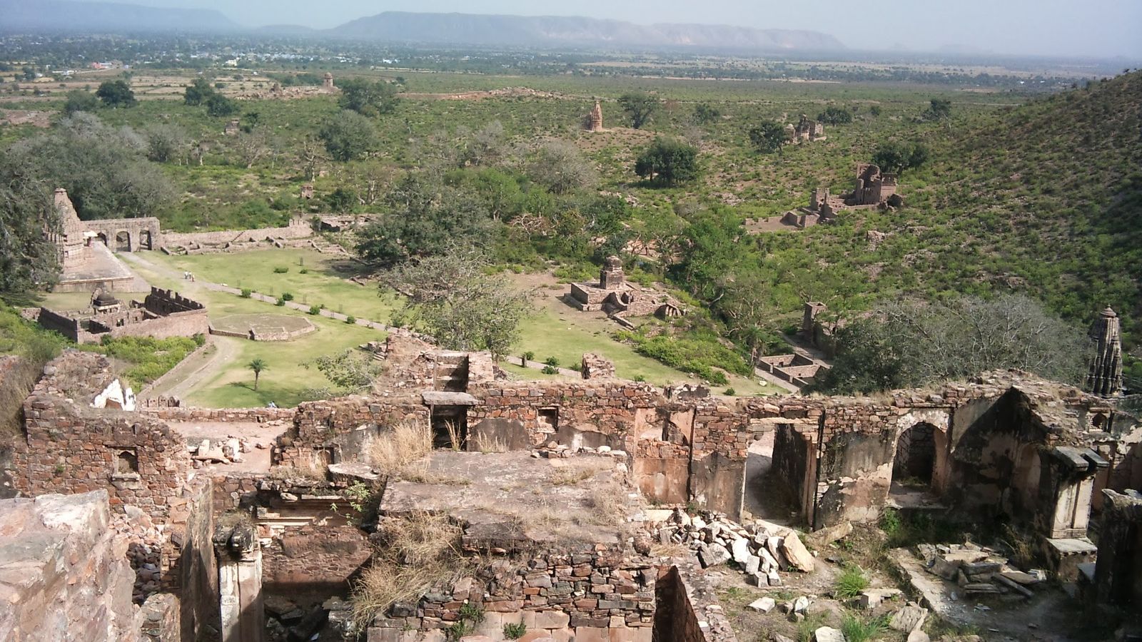 The ruined bazaar street, temples and palace of Bhangarh against the Aravalli hills
