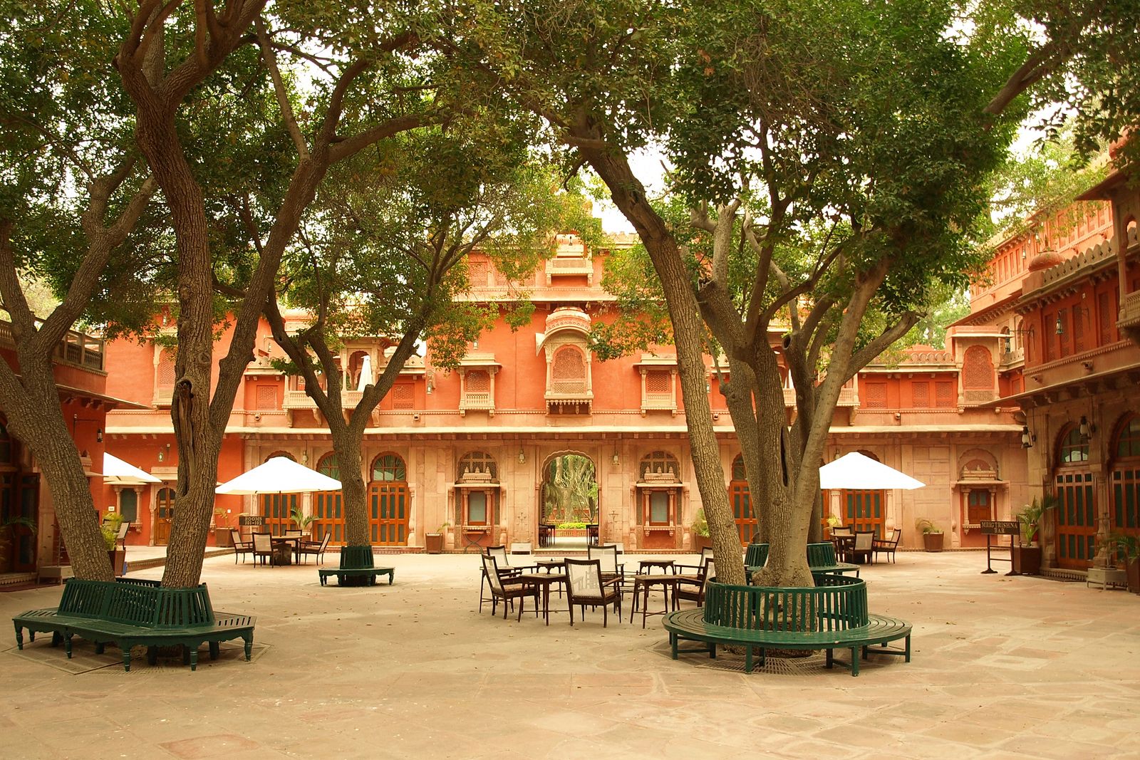 The red sandstone pavilions of Gajner Palace on the edge of its lake near Bikaner