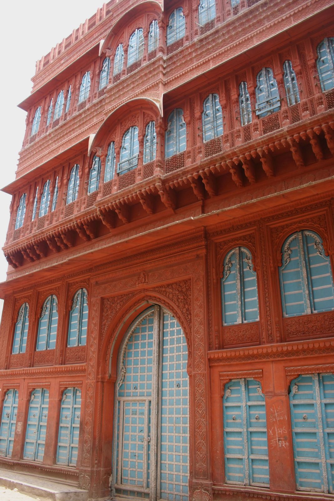 Carved red sandstone facades of the Rampuria havelis lining a lane in Bikaner's old city
