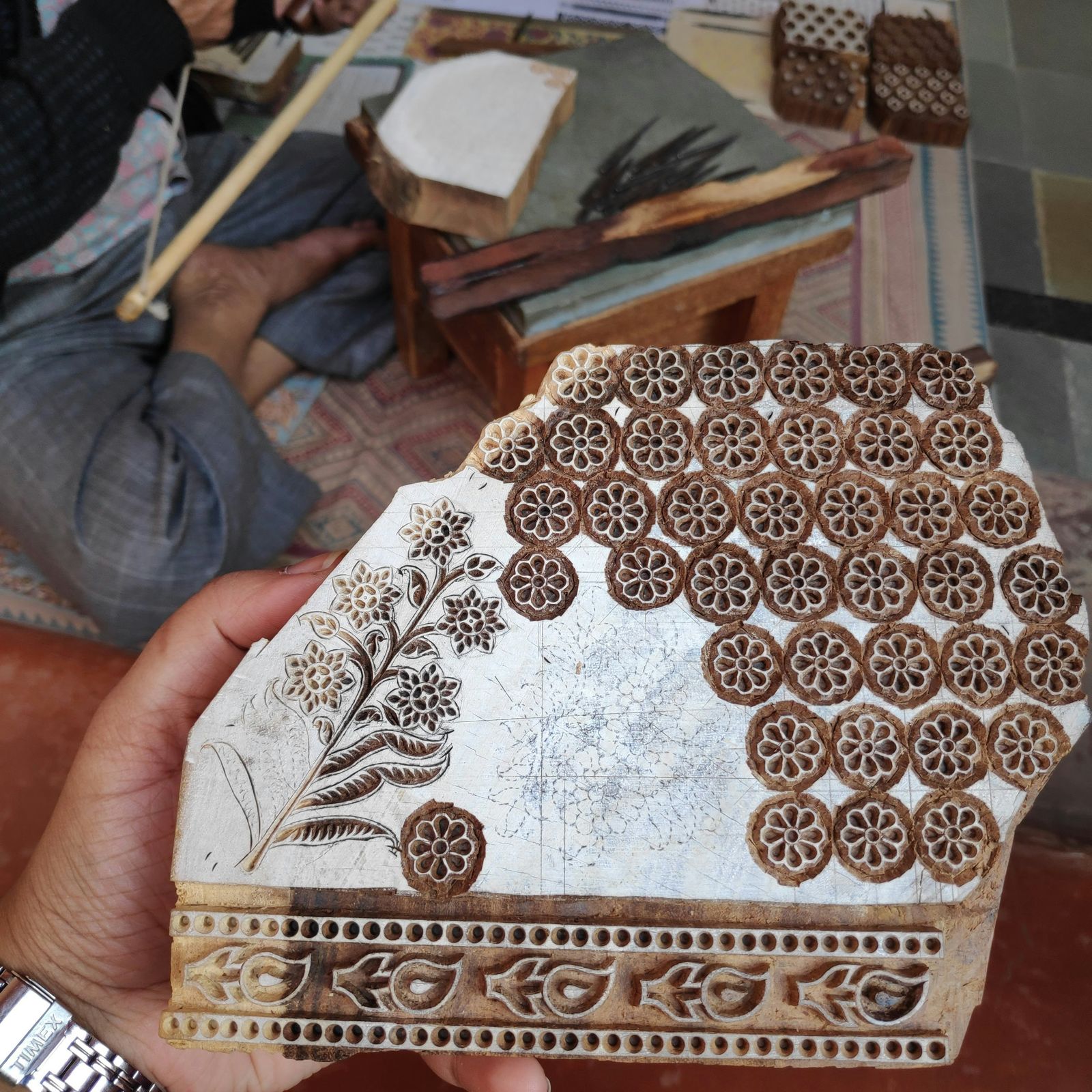 A master craftsman carving a wooden block for textile printing