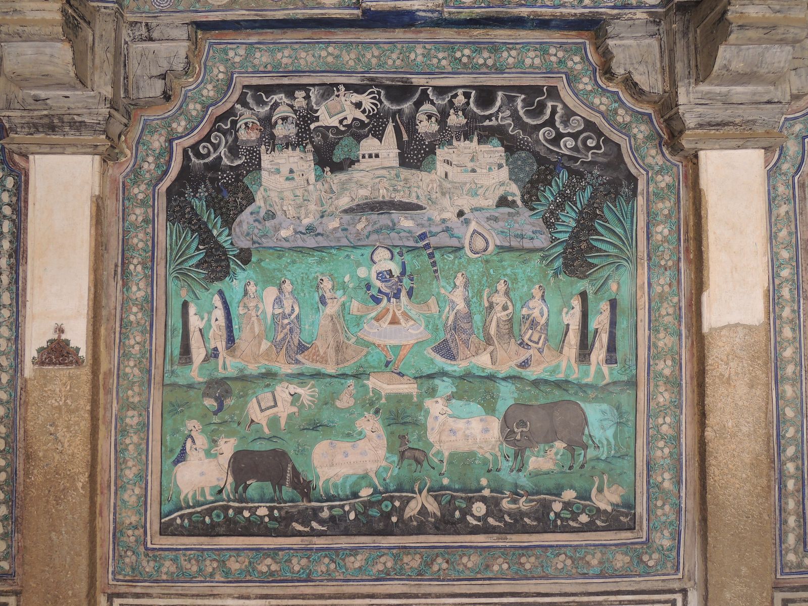 A Chitrashala mural in Bundi's Garh Palace showing Krishna lifting Mount Govardhan to shelter the villagers
