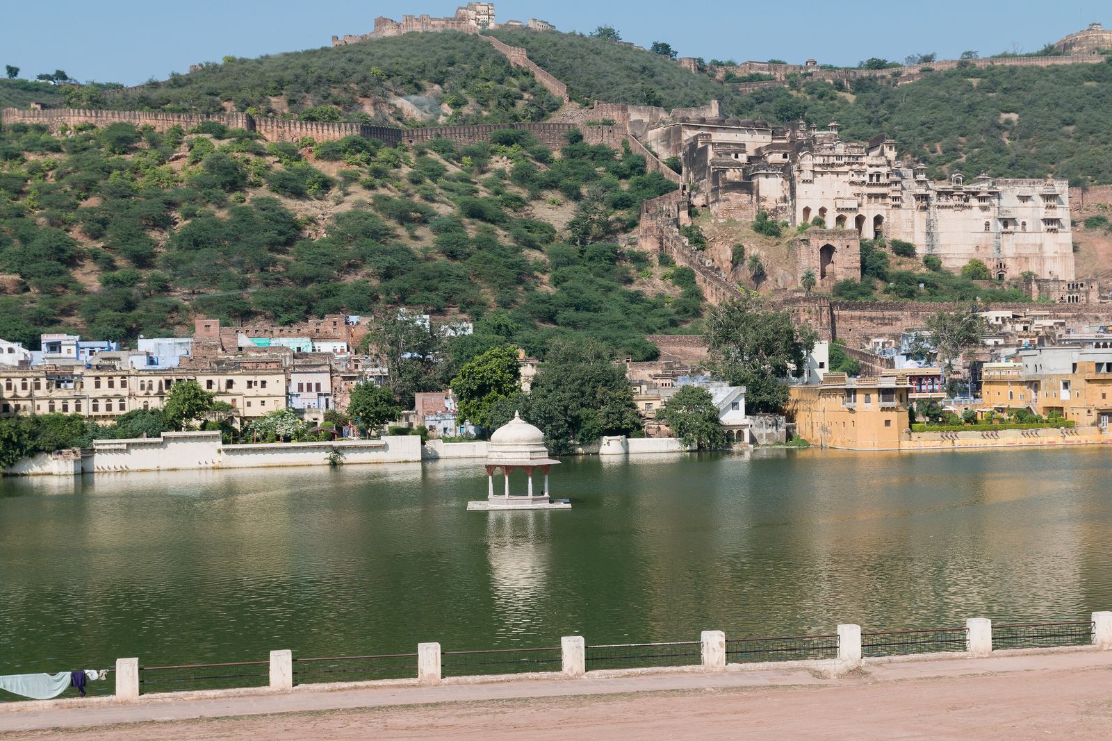 Nawal Sagar lake in Bundi with its small half-submerged temple and the Garh Palace on the hill behind