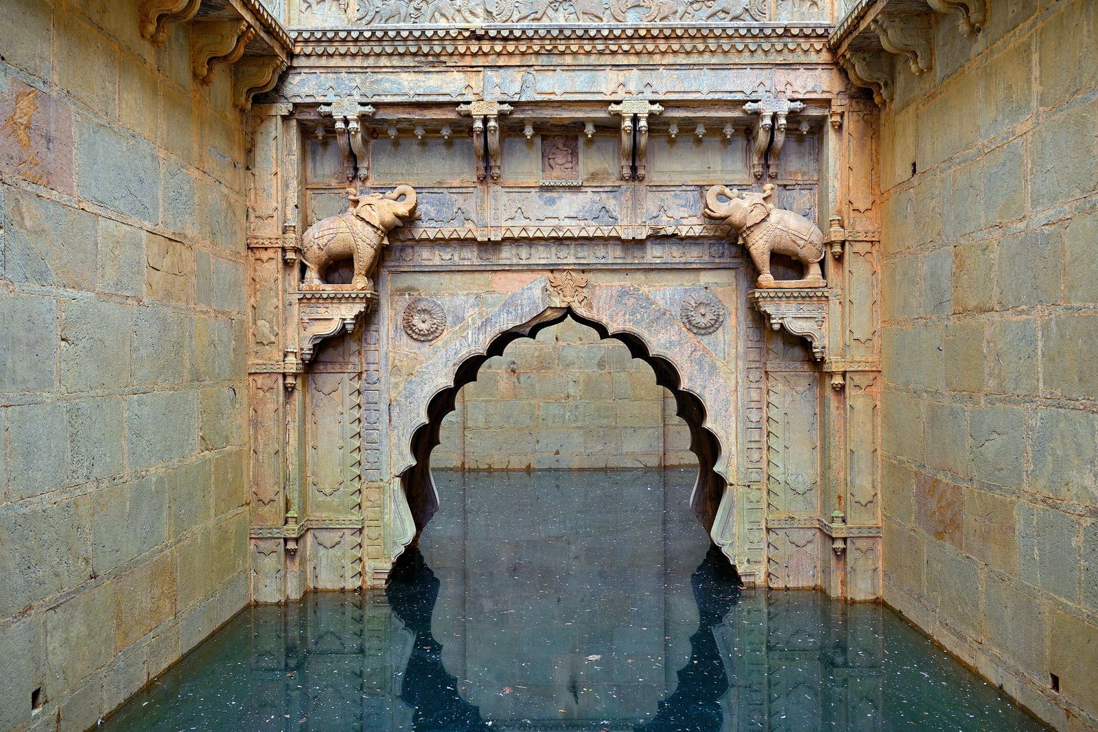 Carved stone arches framing the long flight of steps down into Raniji ki Baori in Bundi