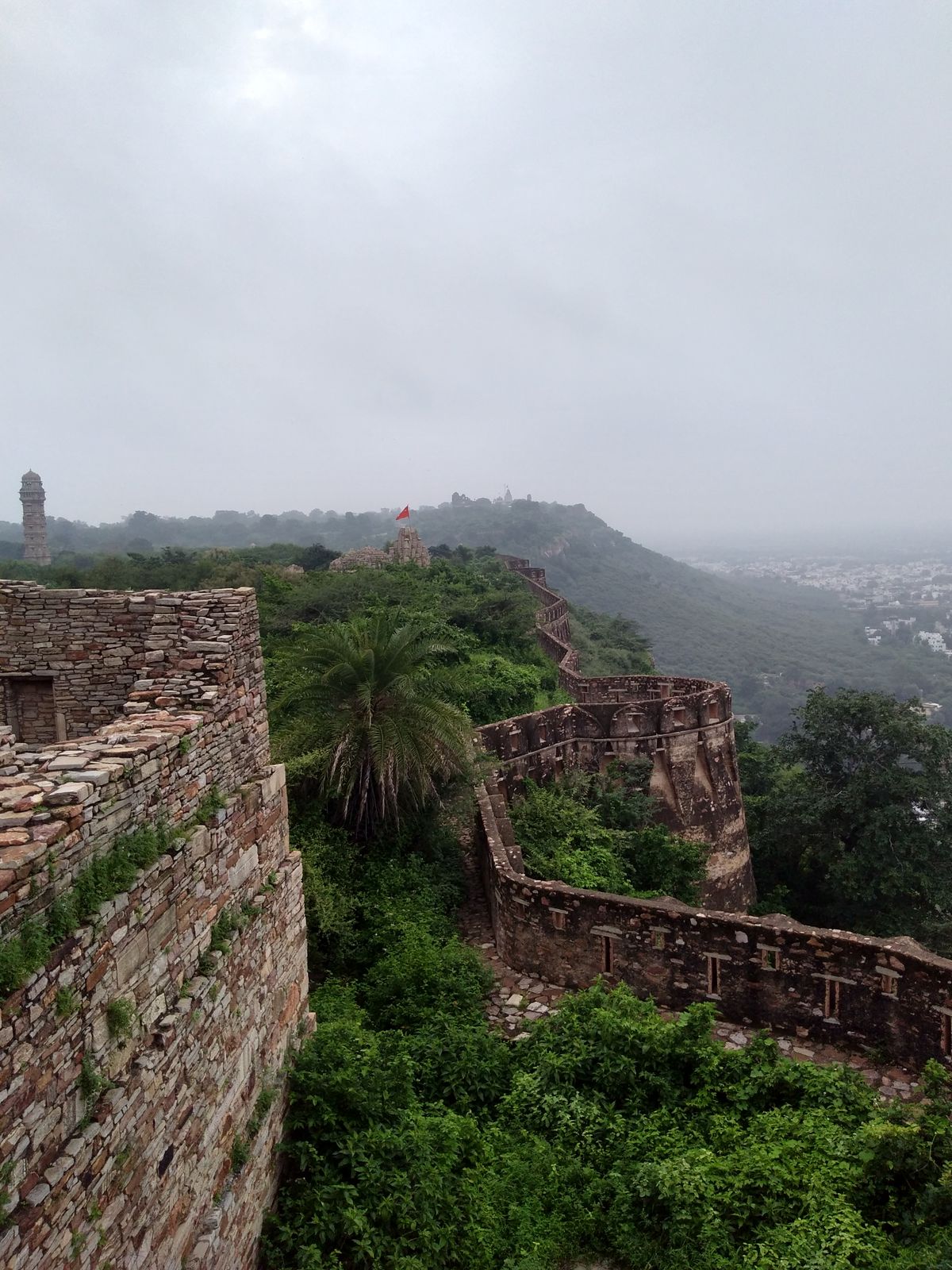 The long ramparts of Chittorgarh Fort on its plateau under a monsoon sky