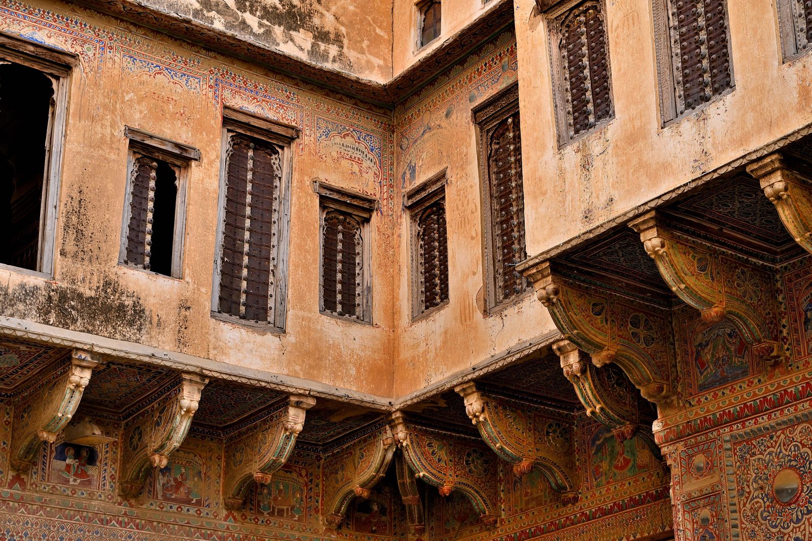 The tall, many-windowed facade of the Surana Haveli rising above a lane in Churu