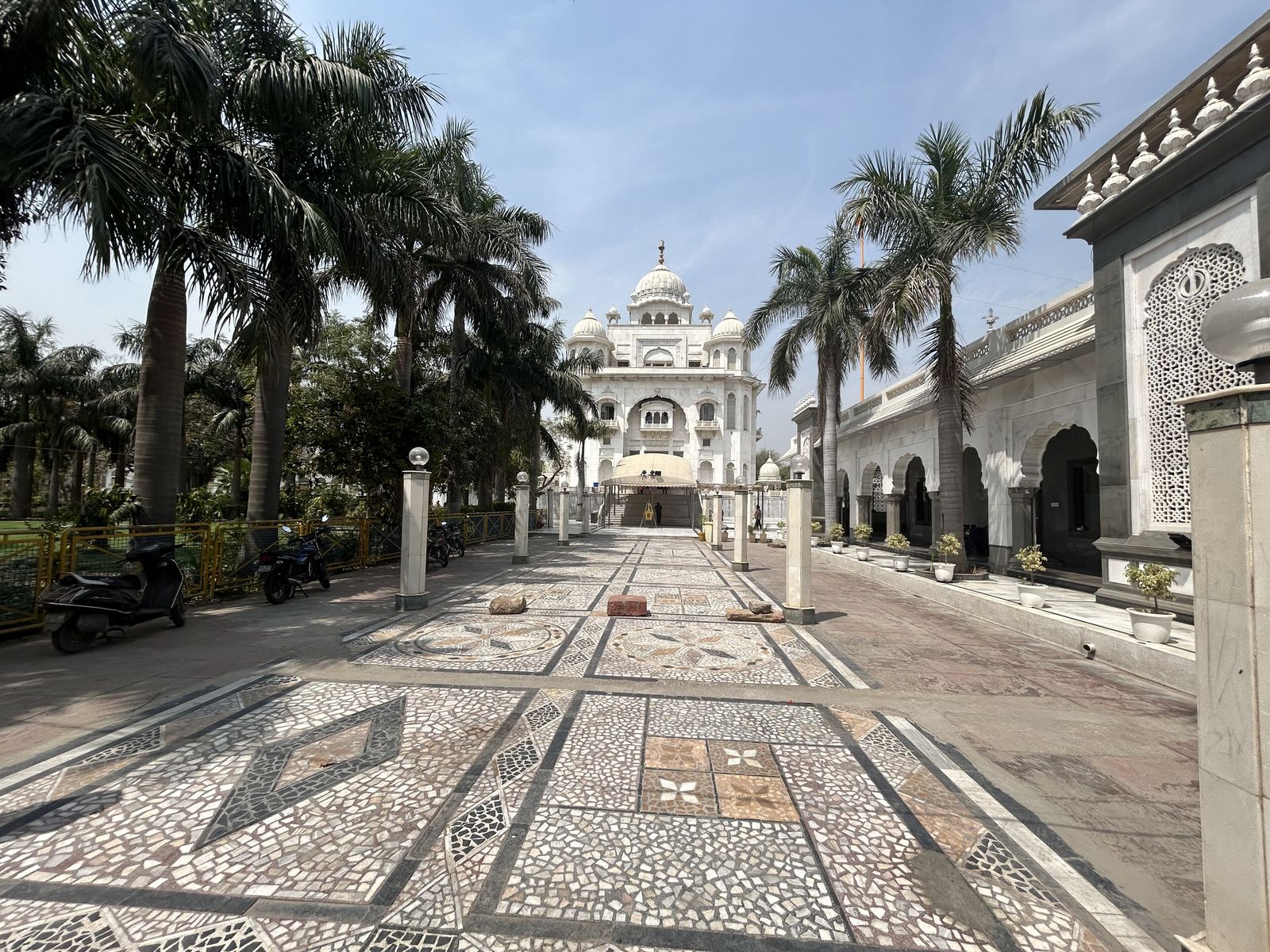 The white marble gurdwara and golden dome of Gurdwara Bangla Sahib reflected in its sacred tank in New Delhi