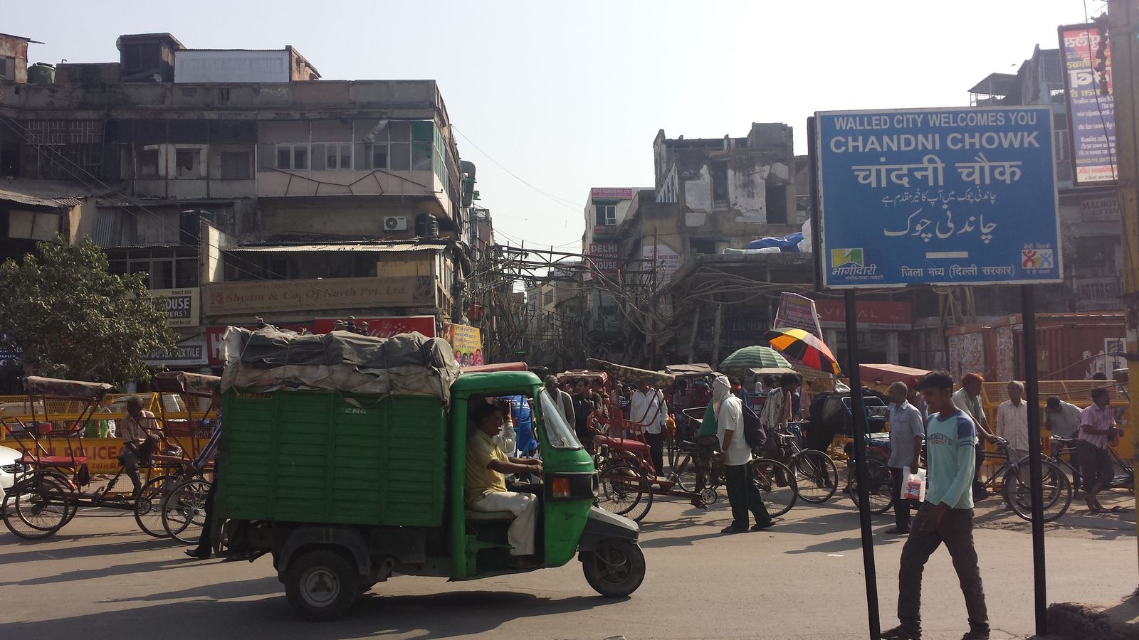 Crowds, shopfronts and cycle rickshaws on Chandni Chowk in Old Delhi
