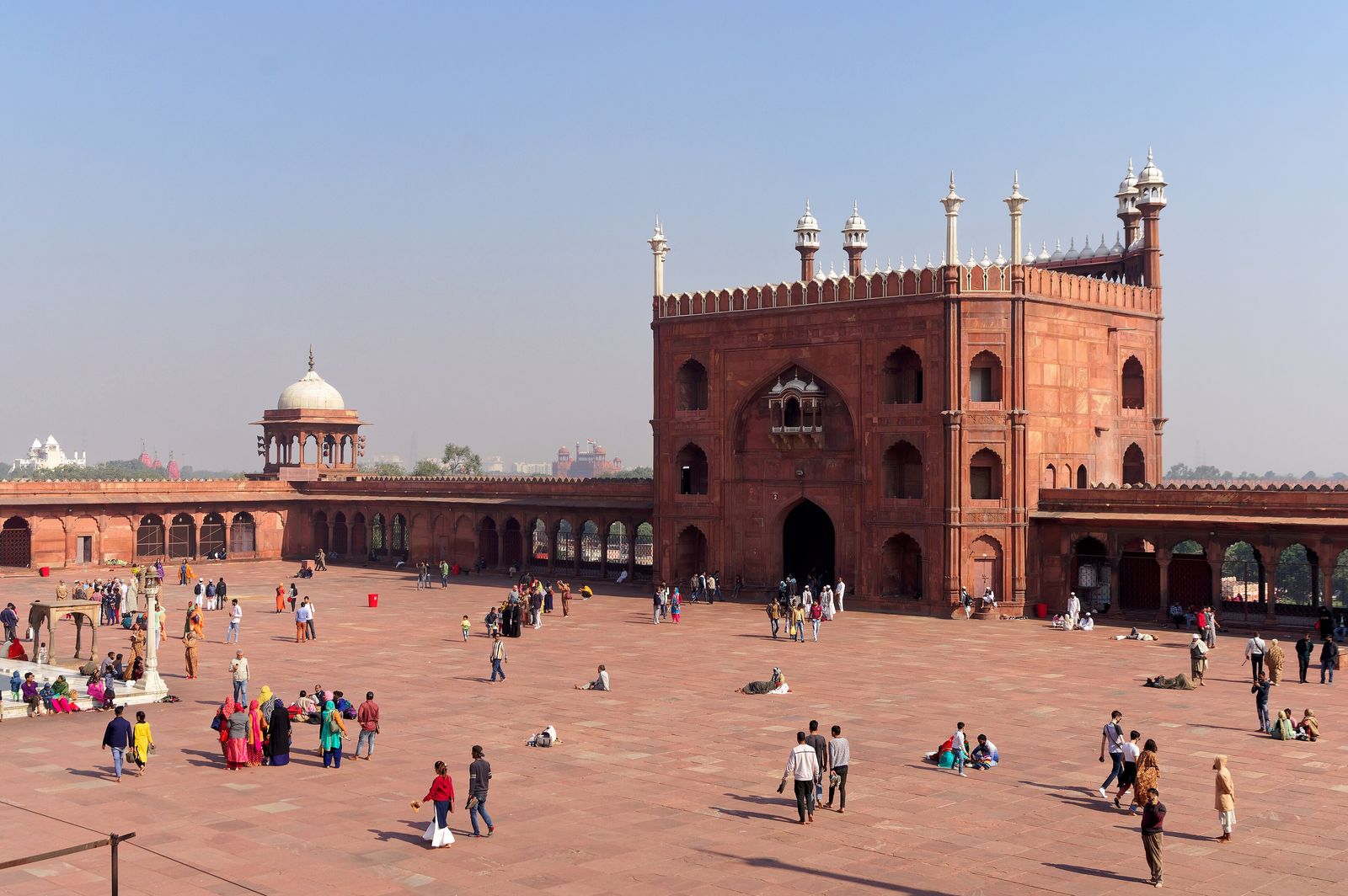 The red sandstone gateway and marble domes of the Jama Masjid in Old Delhi seen from its steps