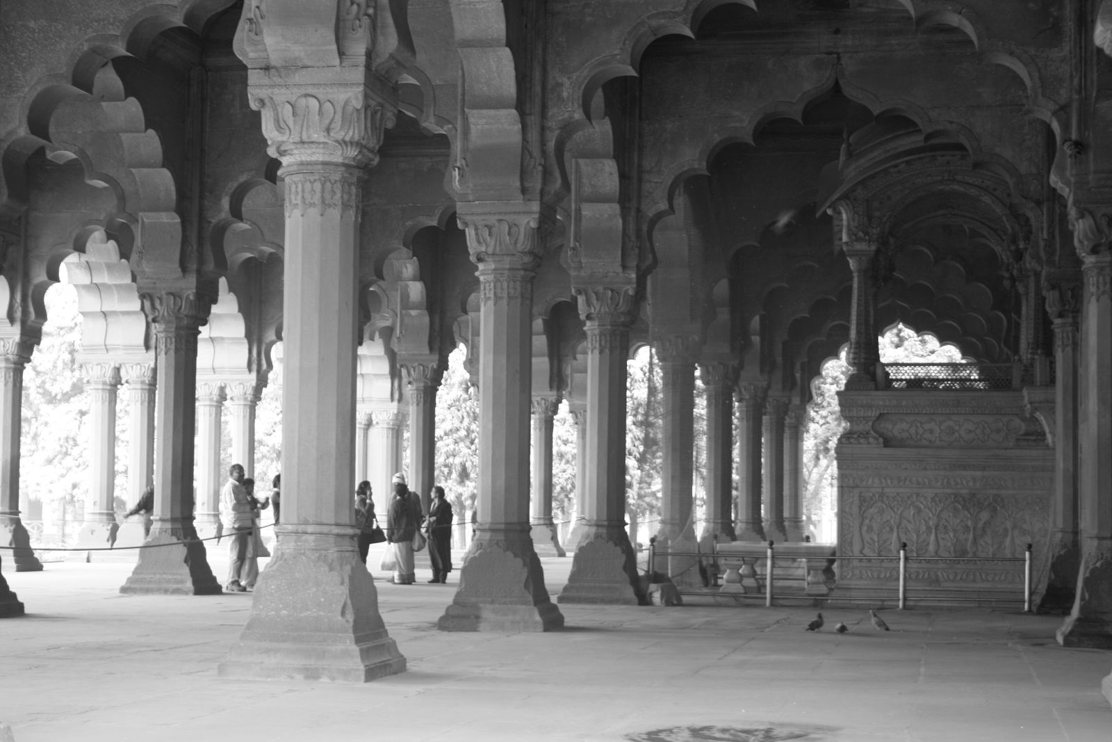 The arcaded red sandstone hall of the Diwan-i-Aam at the Red Fort with the marble throne canopy at its back