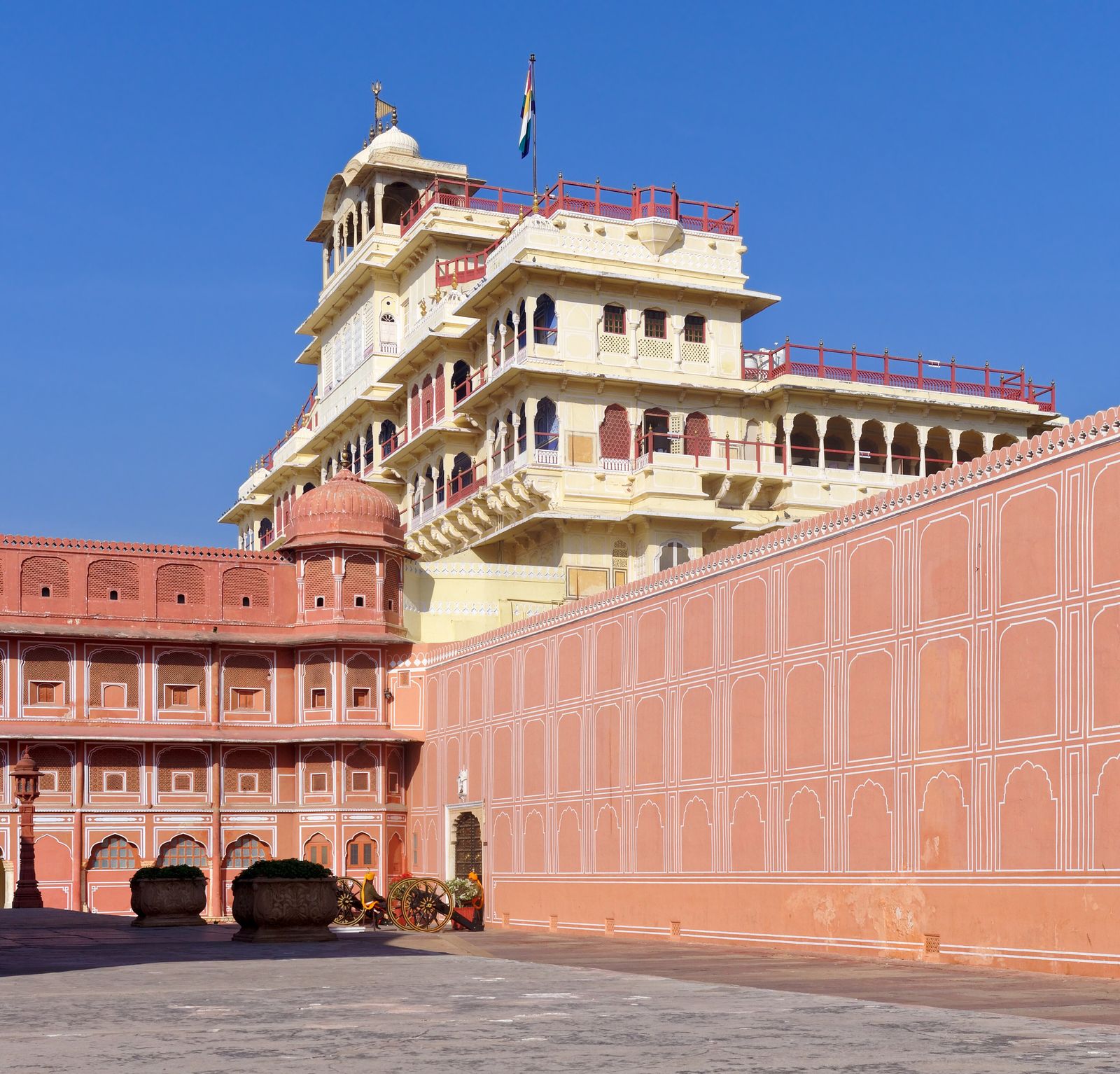 The seven-storeyed Chandra Mahal of the City Palace in Jaipur, cream and pink with balconies and a flag flying above