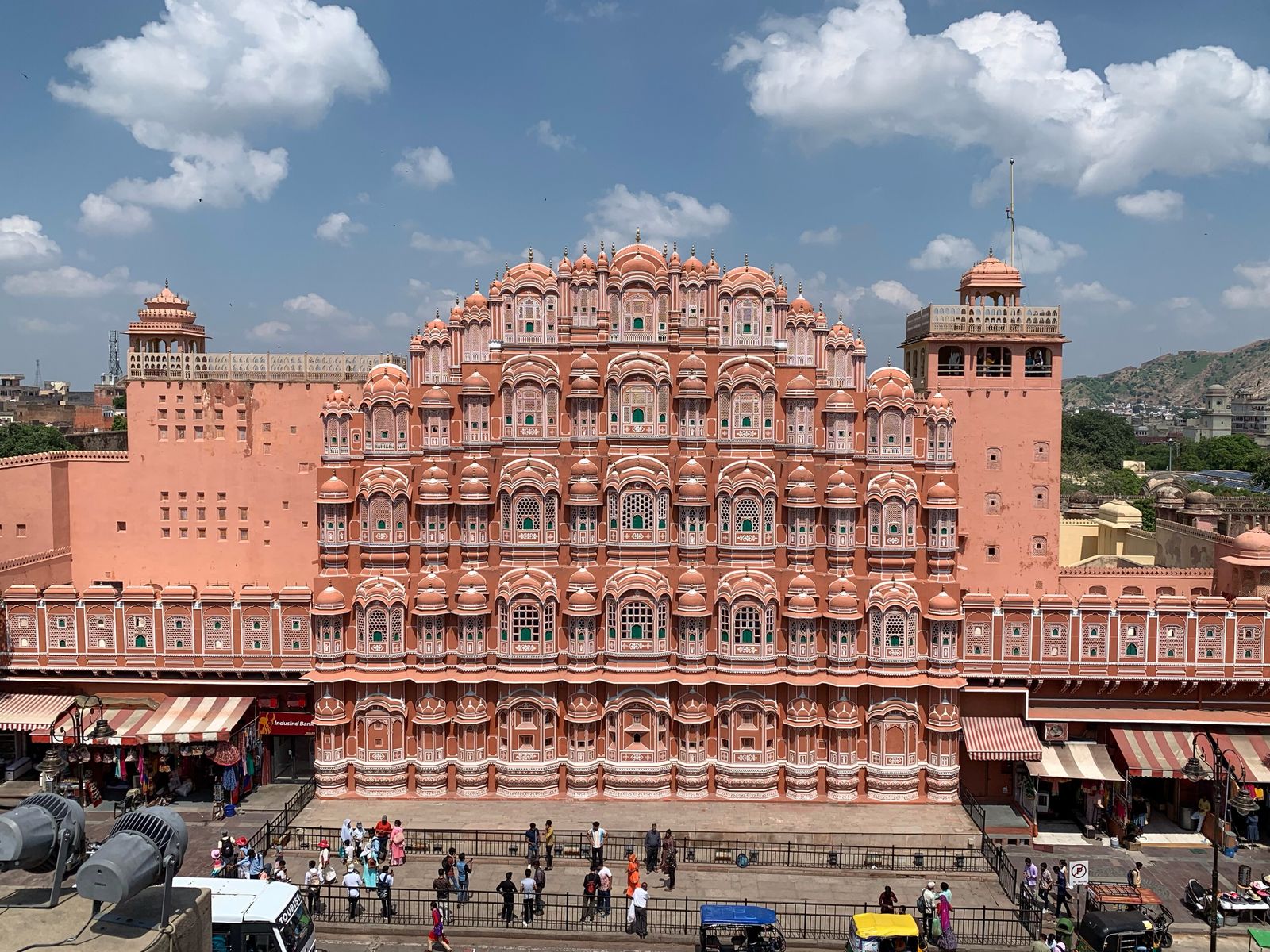 The pink honeycomb facade of Hawa Mahal seen from across the street in Jaipur