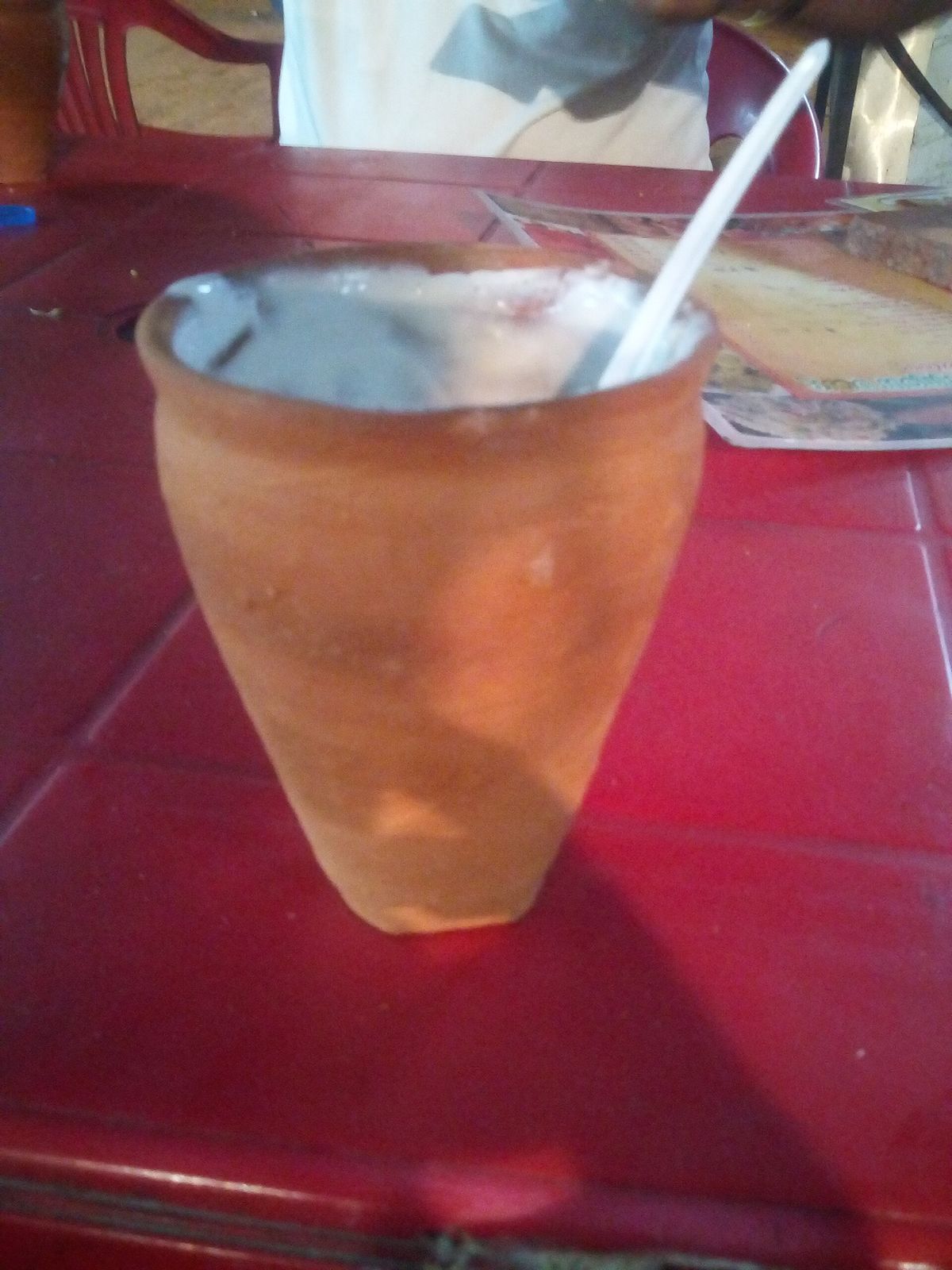 Thick lassi topped with cream in an unglazed clay kulhad cup