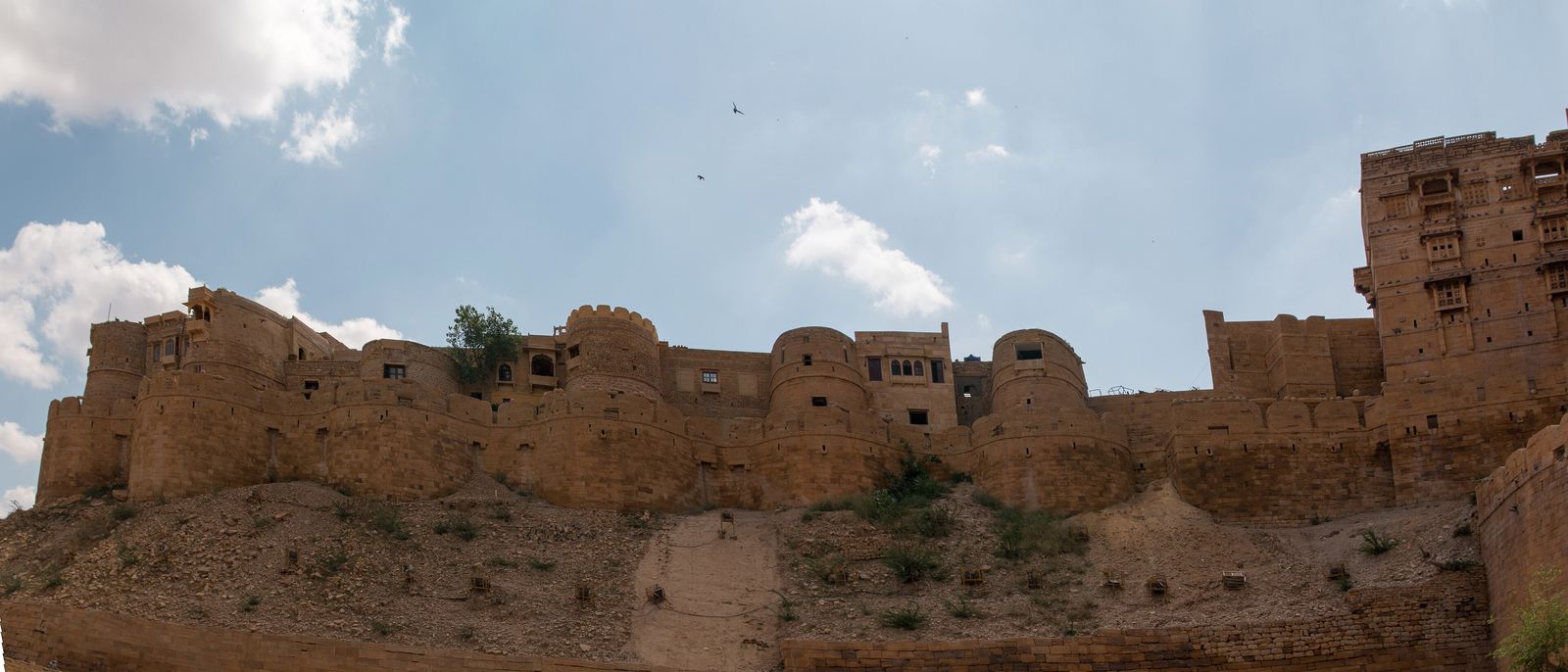 The round sandstone bastions of Jaisalmer Fort's south-east wall glowing in the sun