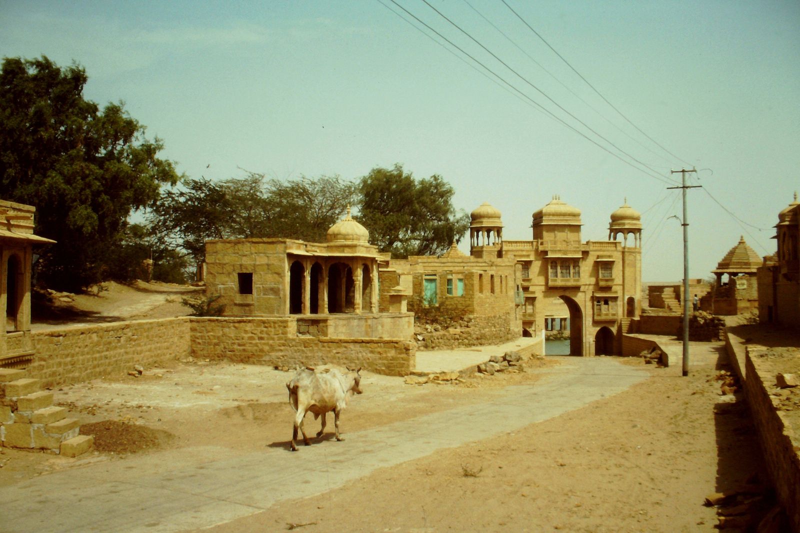 The carved yellow sandstone arch of Tilon ki Pol, the gateway leading down to Gadisar Lake in Jaisalmer