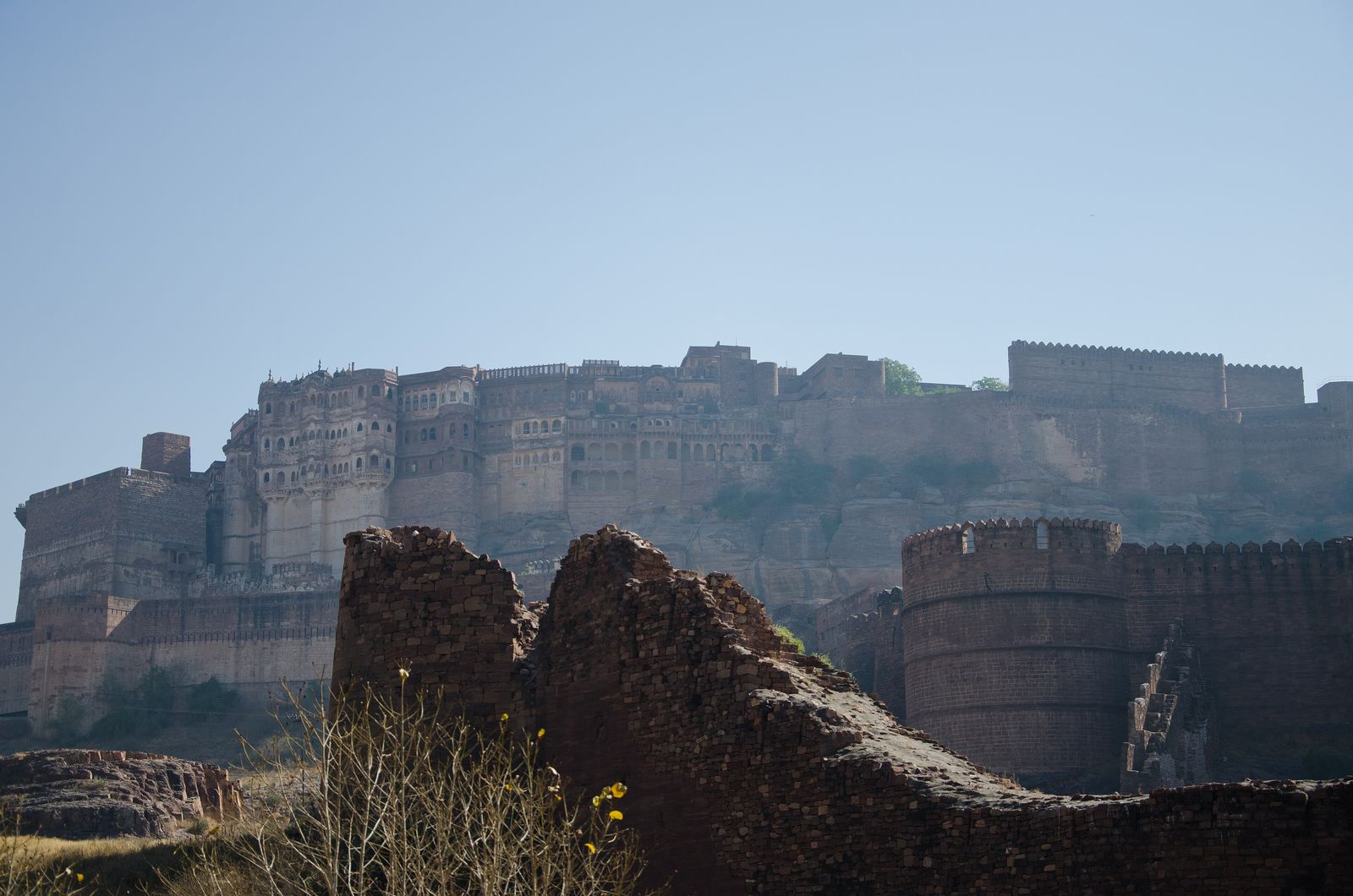 The walls of Mehrangarh Fort rising straight from a sandstone cliff above Jodhpur