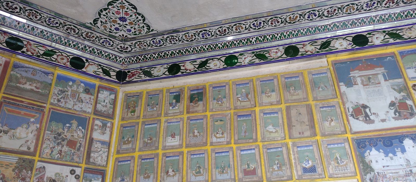 Painted wall and ceiling murals inside a hall of the Garh Palace in Kota