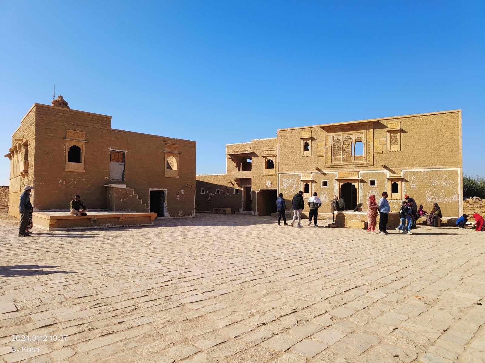 Roofless sandstone houses lining a straight street in the abandoned village of Kuldhara near Jaisalmer