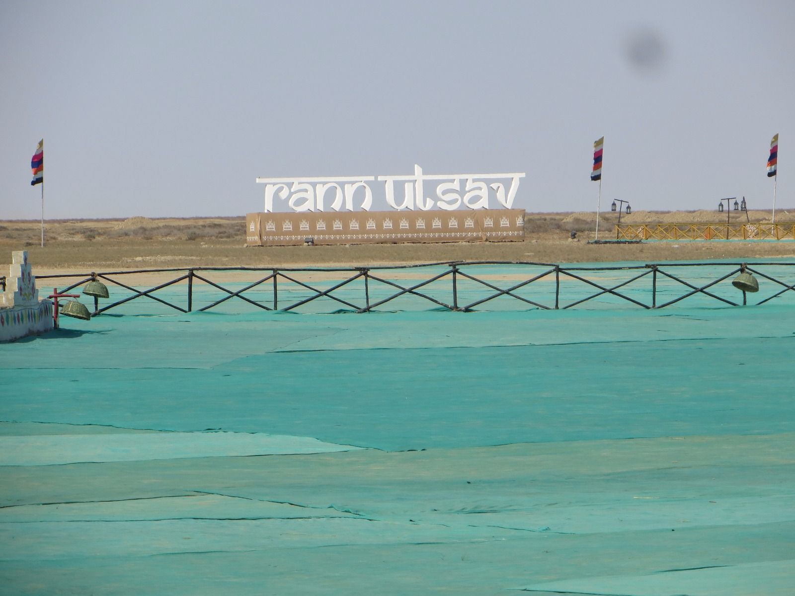 Rows of white festival tents at the Rann Utsav tent city in Dhordo, with the flat Kutch landscape beyond