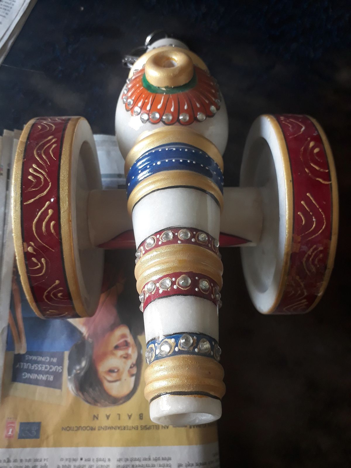 A painted ornament carved from white Makrana marble