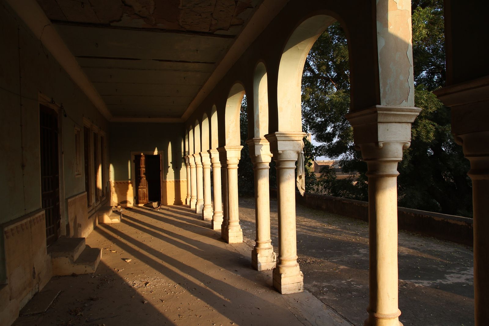 A painted inner courtyard of Castle Mandawa with arched balconies and carved jharokhas