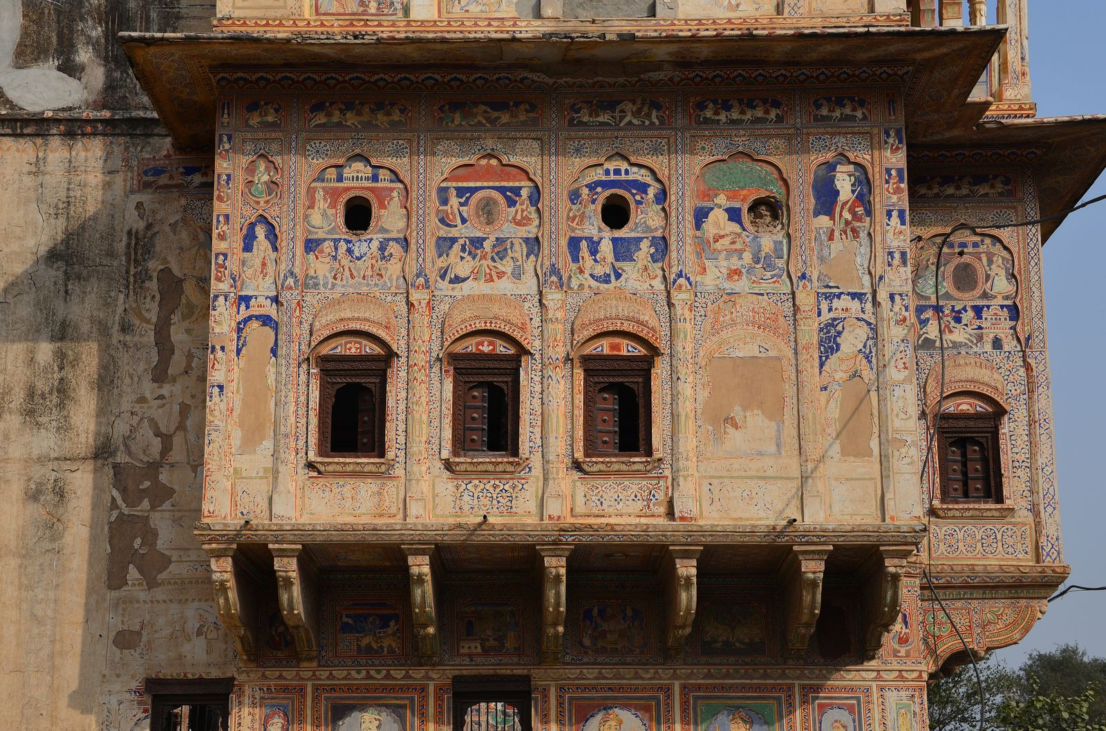 The painted facade and carved gateway of a merchant haveli in Mandawa, Shekhawati
