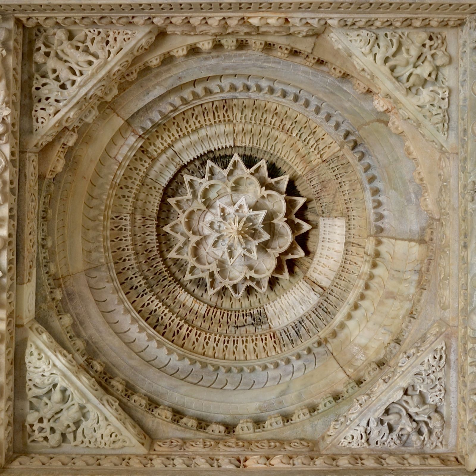 A carved marble ceiling of concentric rings and petals in a shrine of the Luna Vasahi temple at Dilwara