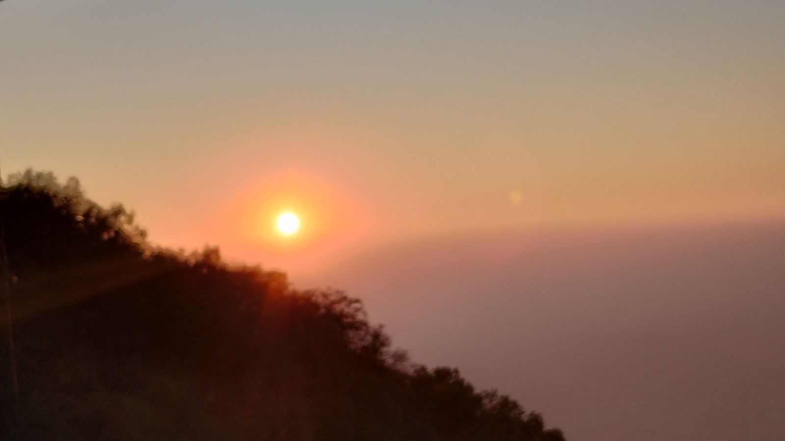 The sun setting over the plains below Sunset Point in Mount Abu