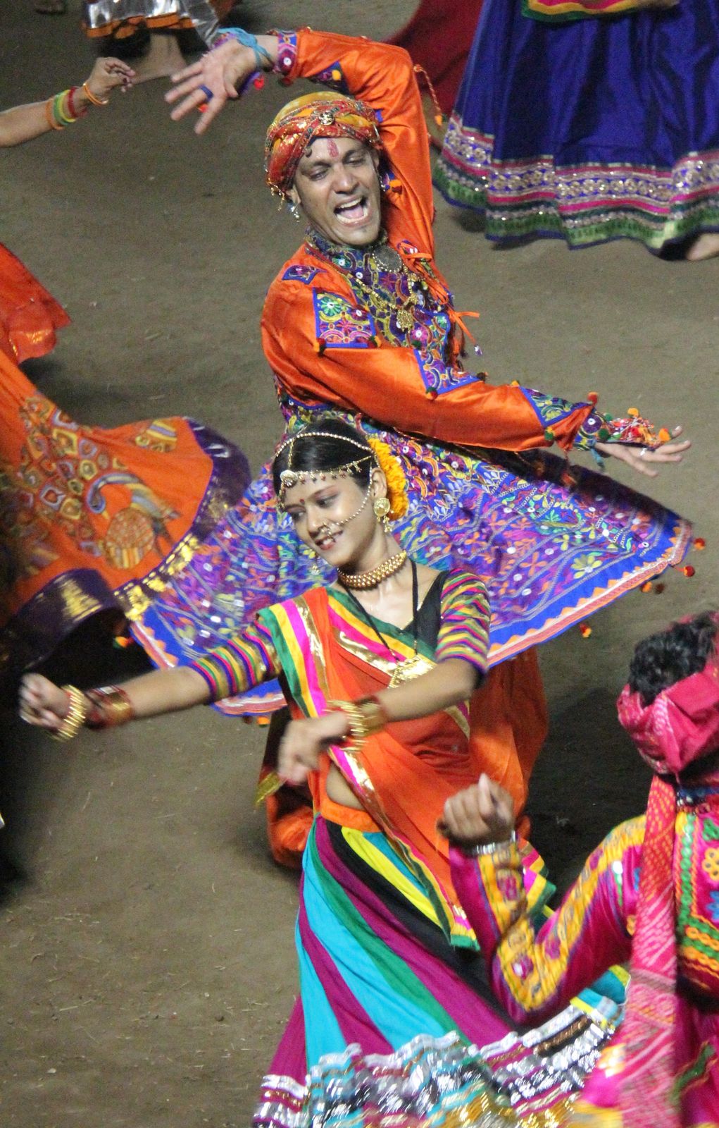 Garba dancers in mirrored skirts whirling during Navratri