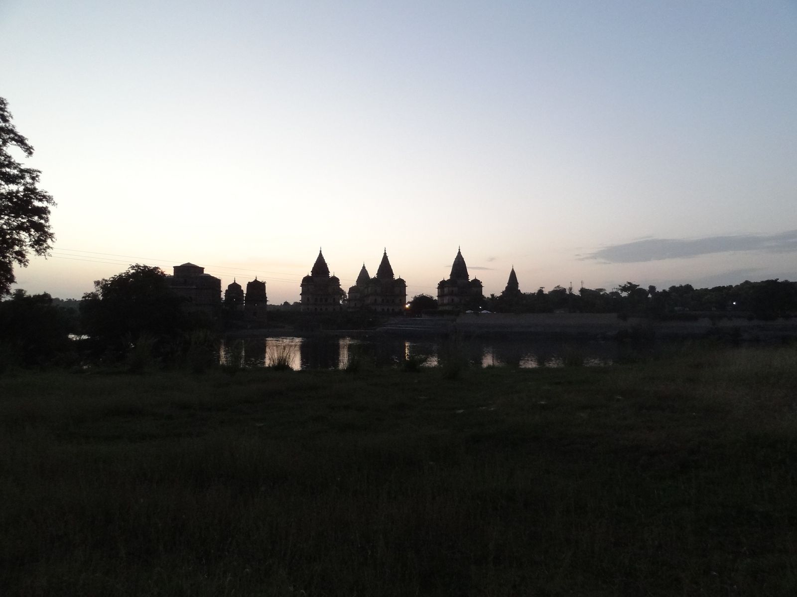 The royal chhatris of Orchha on the bank of the Betwa river at sunset