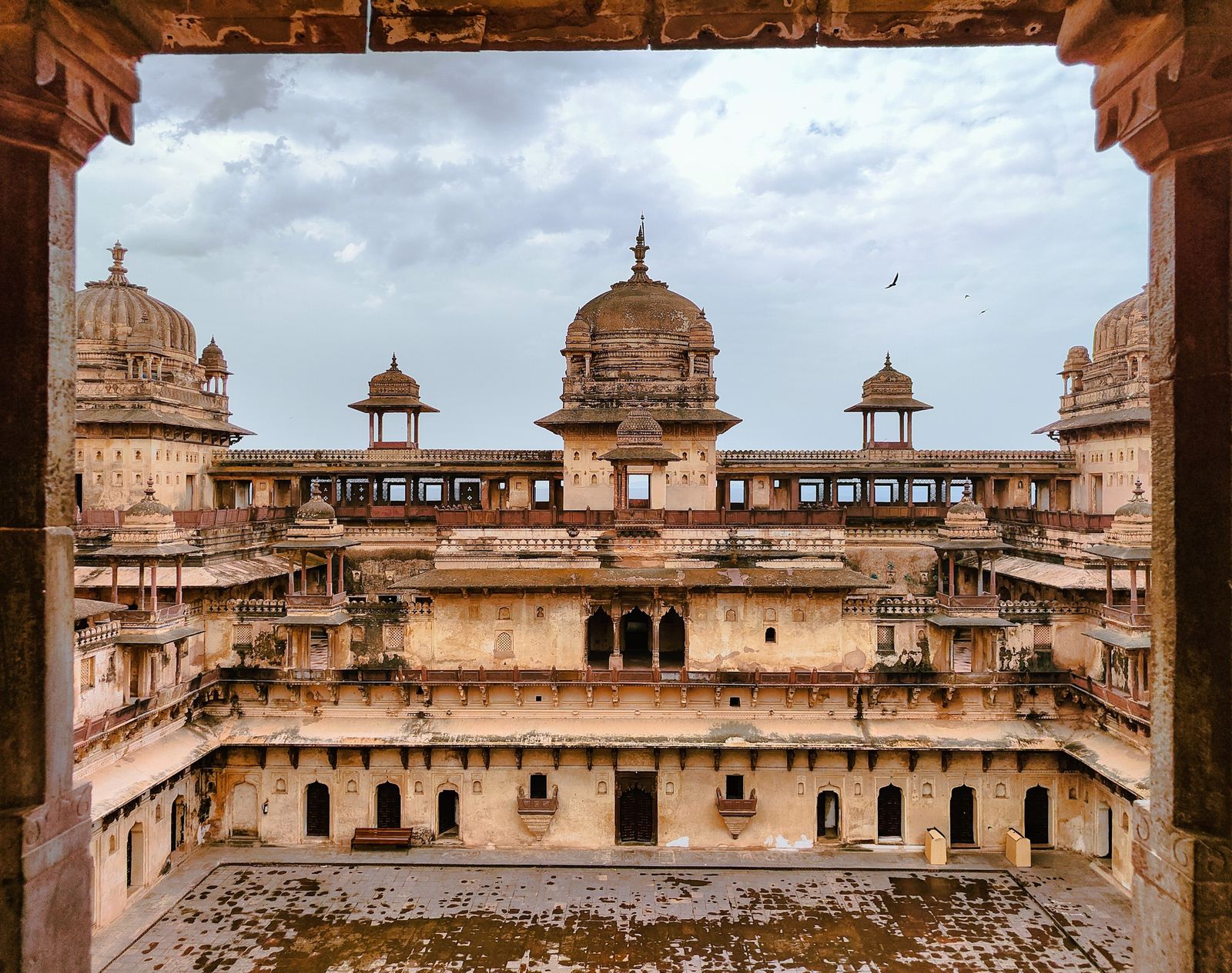 The Jahangir Mahal at Orchha with its domes and arcades in monsoon season
