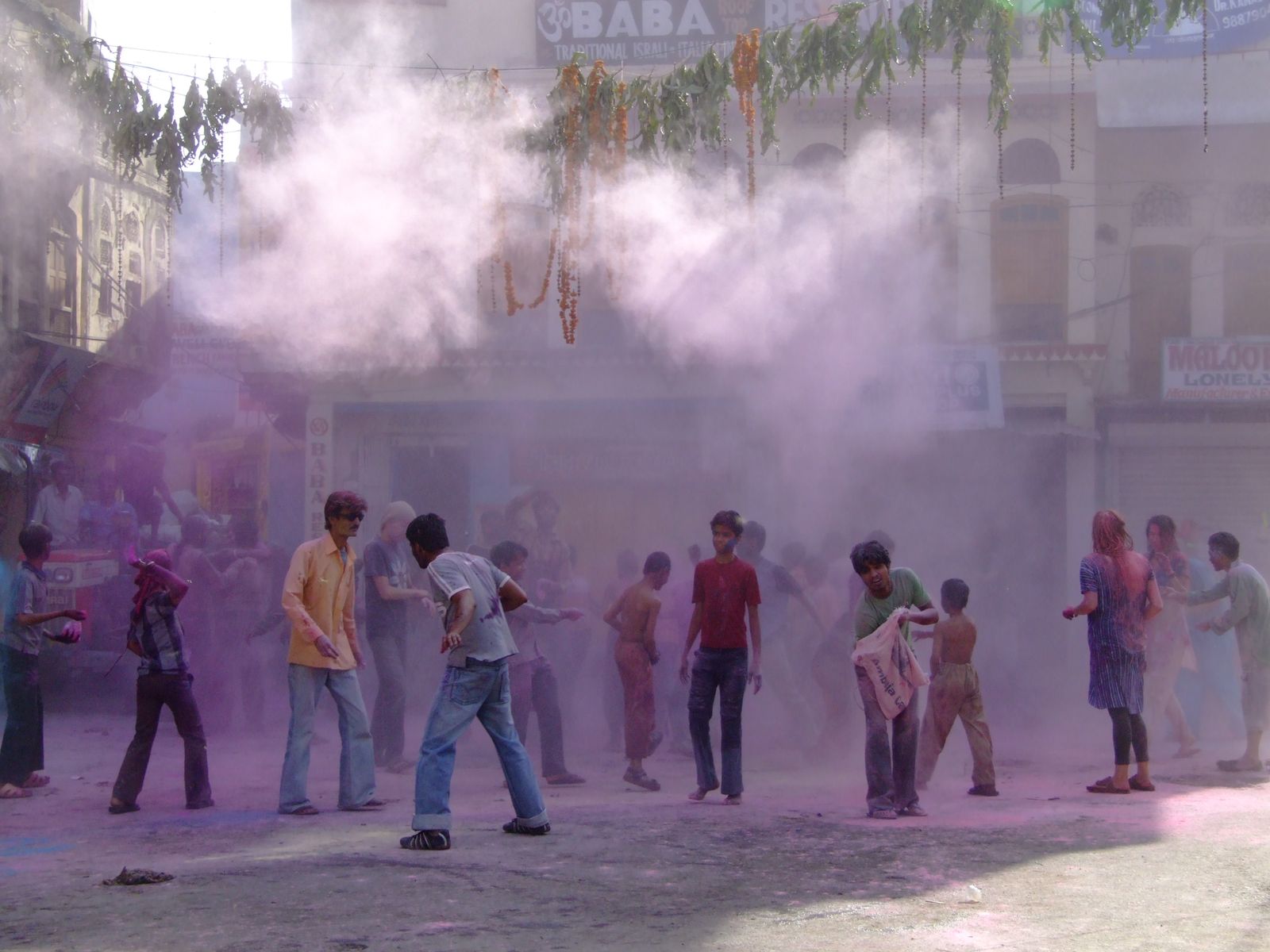 Crowds throwing coloured powder during Holi in Pushkar