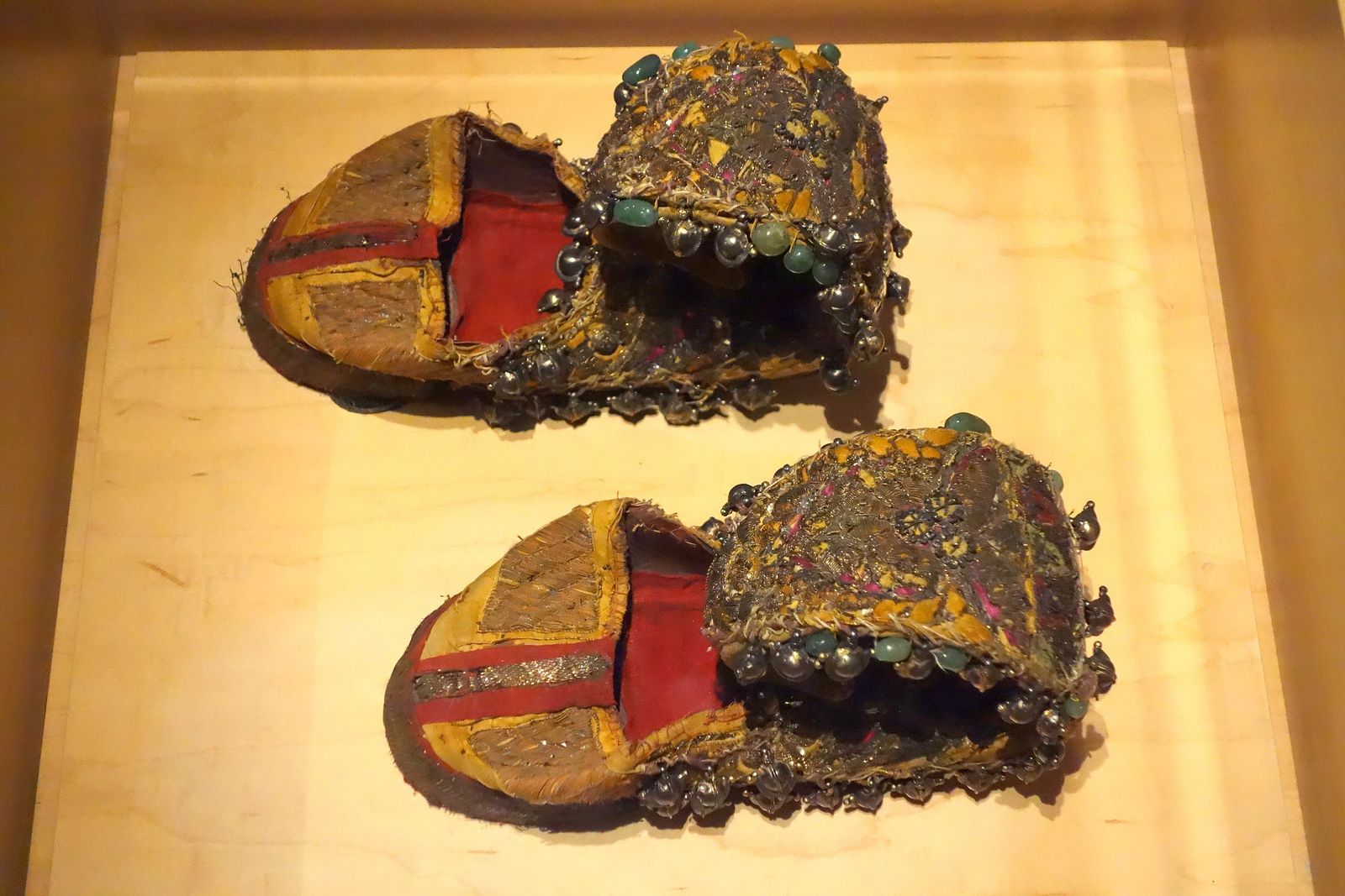 Rows of embroidered leather mojari slippers with pointed toes hanging in a shop in a Rajasthani bazaar