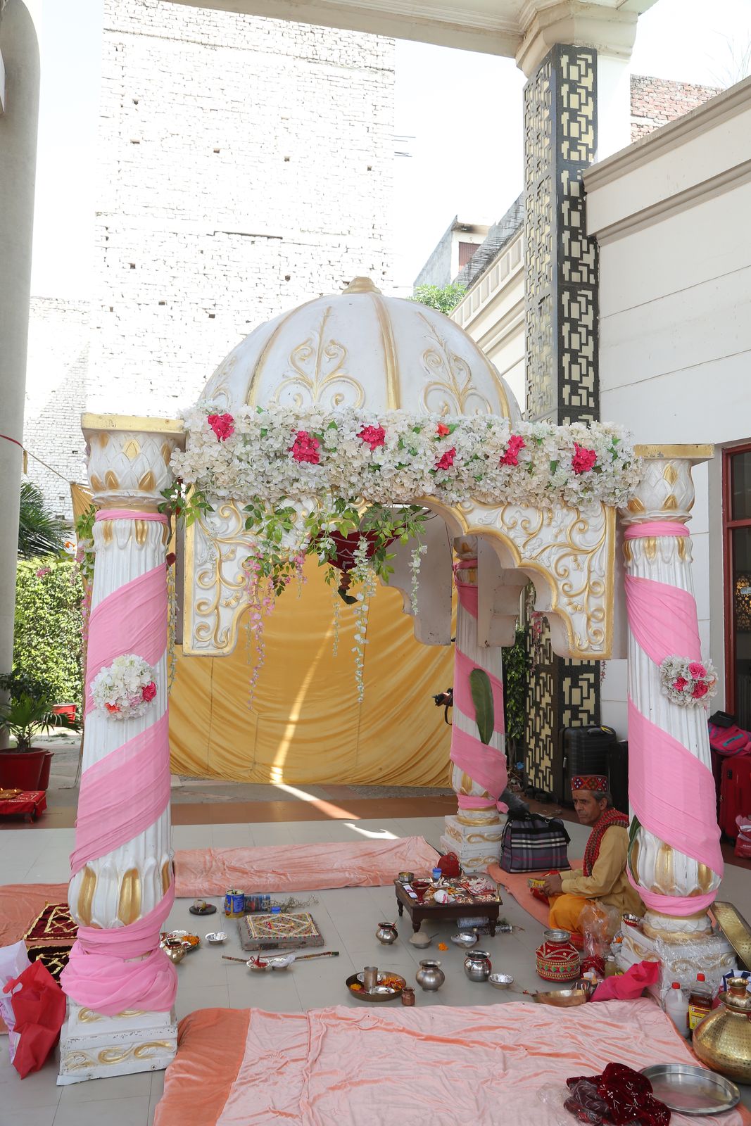 A wedding canopy decorated with marigolds and flowers