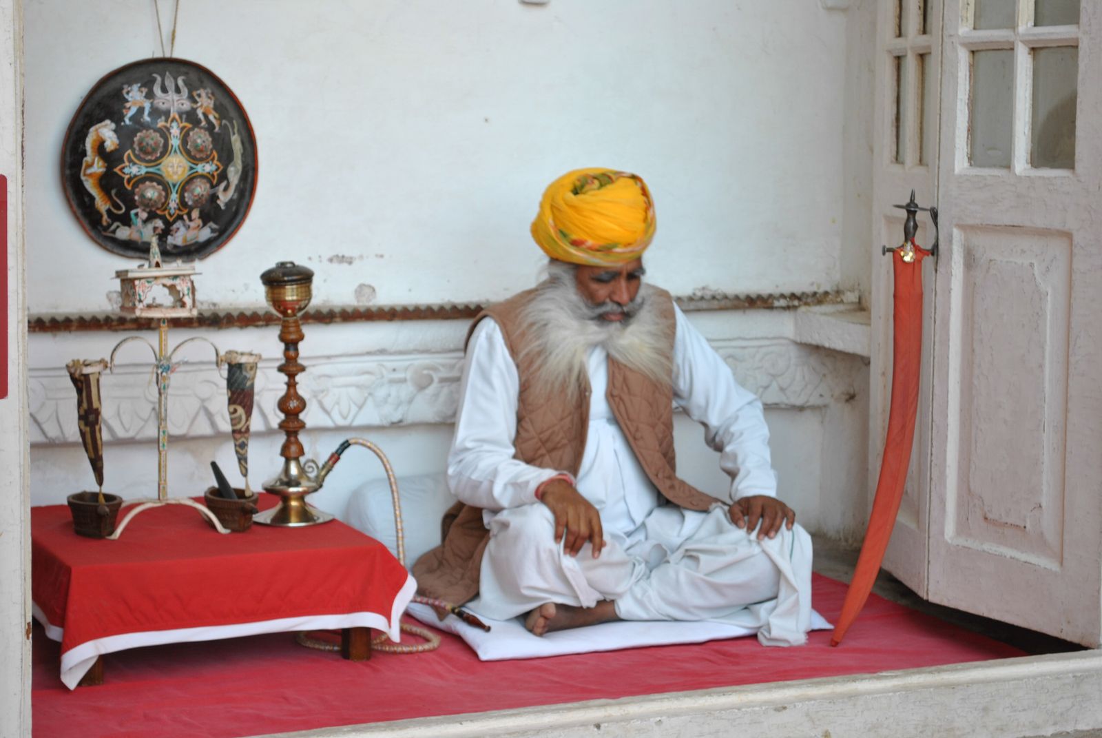 An elderly man in a traditional Rajasthani turban and white clothes at Mehrangarh Fort