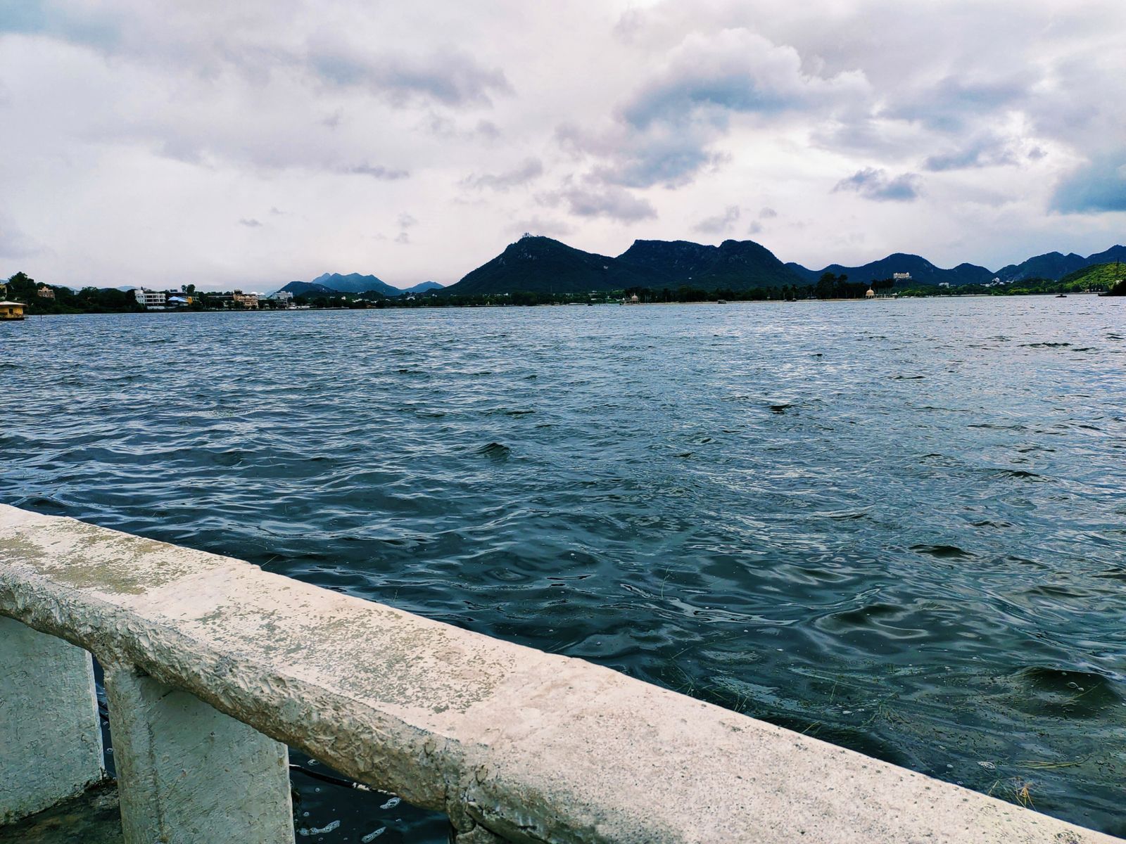 Fateh Sagar Lake in Udaipur, with its islands and the green Aravalli hills rising around the water