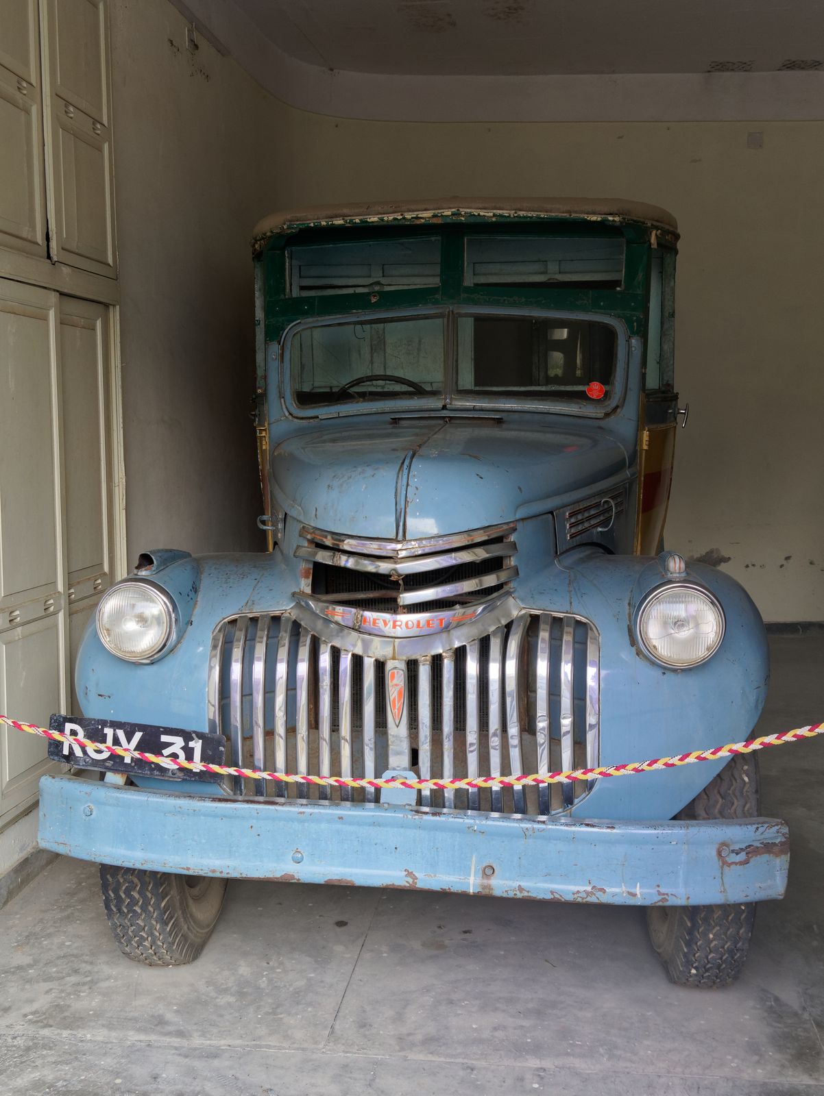 Polished vintage Rolls-Royce and Cadillac cars parked in the old royal garage of the Vintage and Classic Car Collection in Udaipur