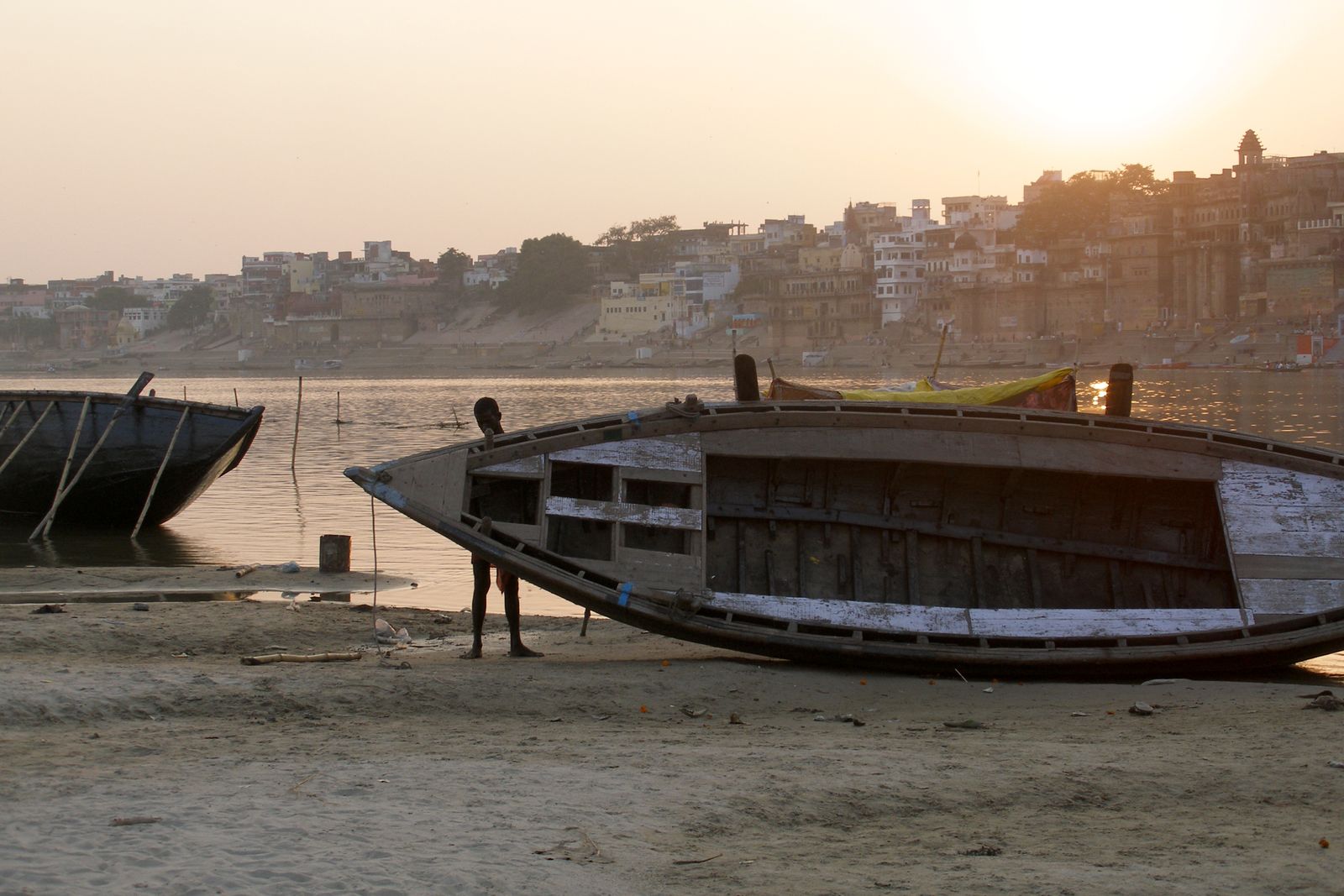 Wooden rowing boats moored below the ghats of Varanasi on the Ganga