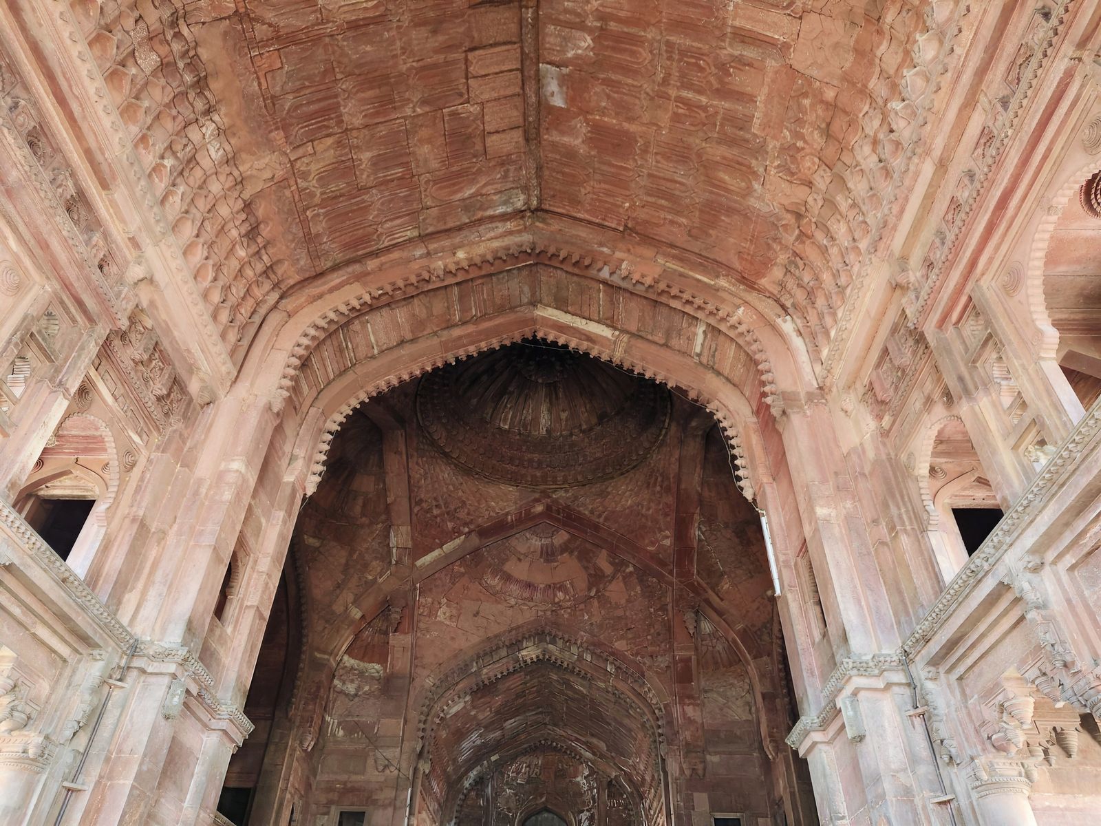 The red sandstone walls and carved arches of the Govind Dev temple at Vrindavan